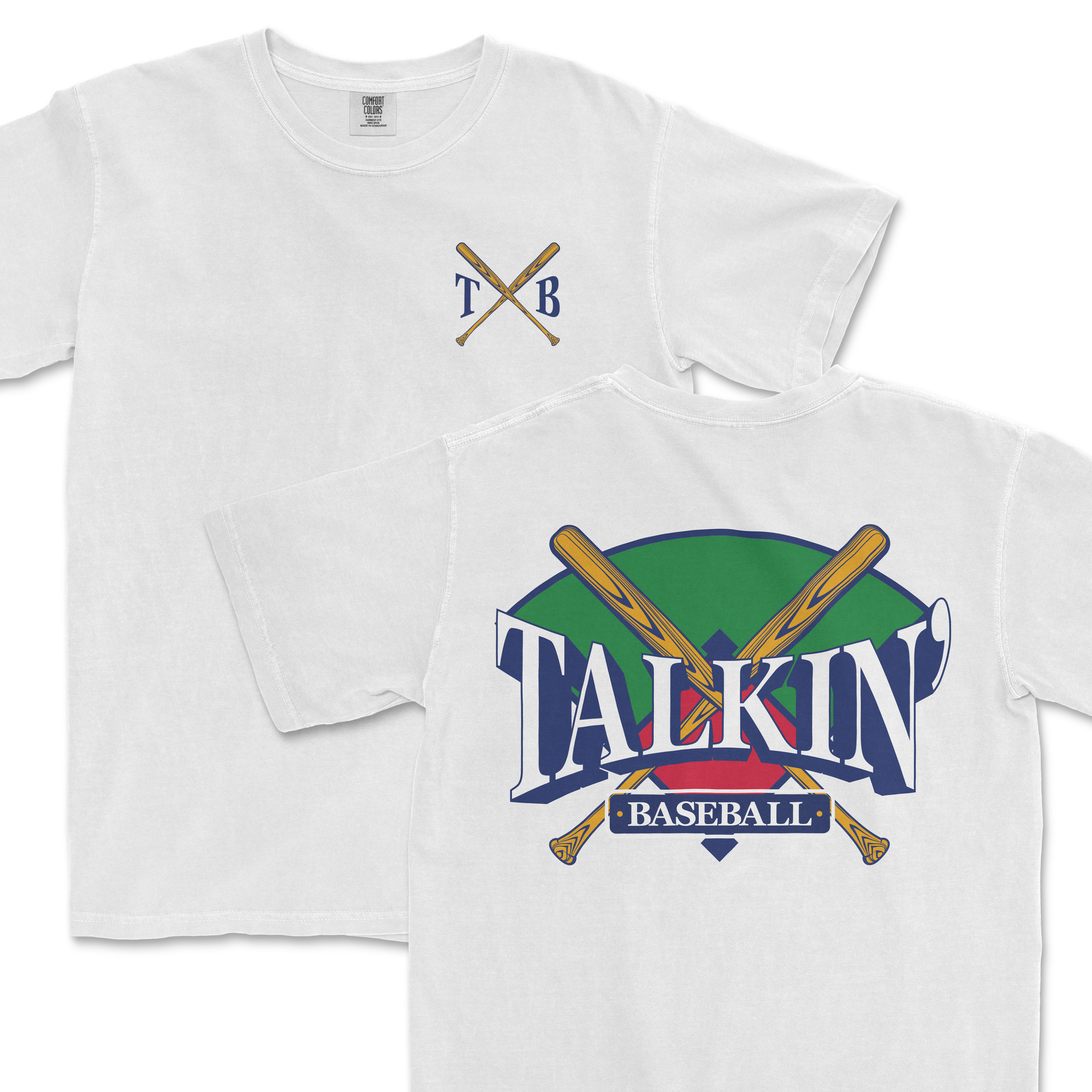 White Comfort Colors tee featuring a graphic design with crossed baseball bats and the text "Talkin' Baseball" in stylized lettering, with a green and purple background. The upper left corner includes a simple crest with the initials "TXB".
