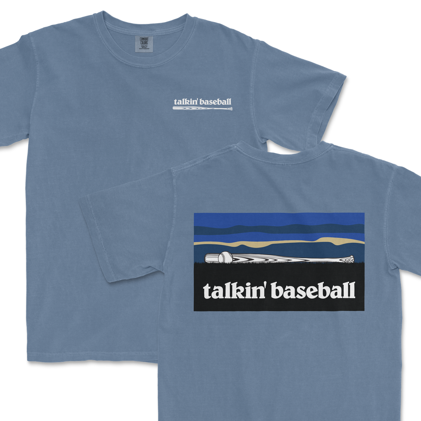 Light blue T-shirt featuring a small "talkin' baseball" logo with a baseball bat and ball on the front, and a larger graphic of a baseball bat and ball against a stylized landscape on the back.
