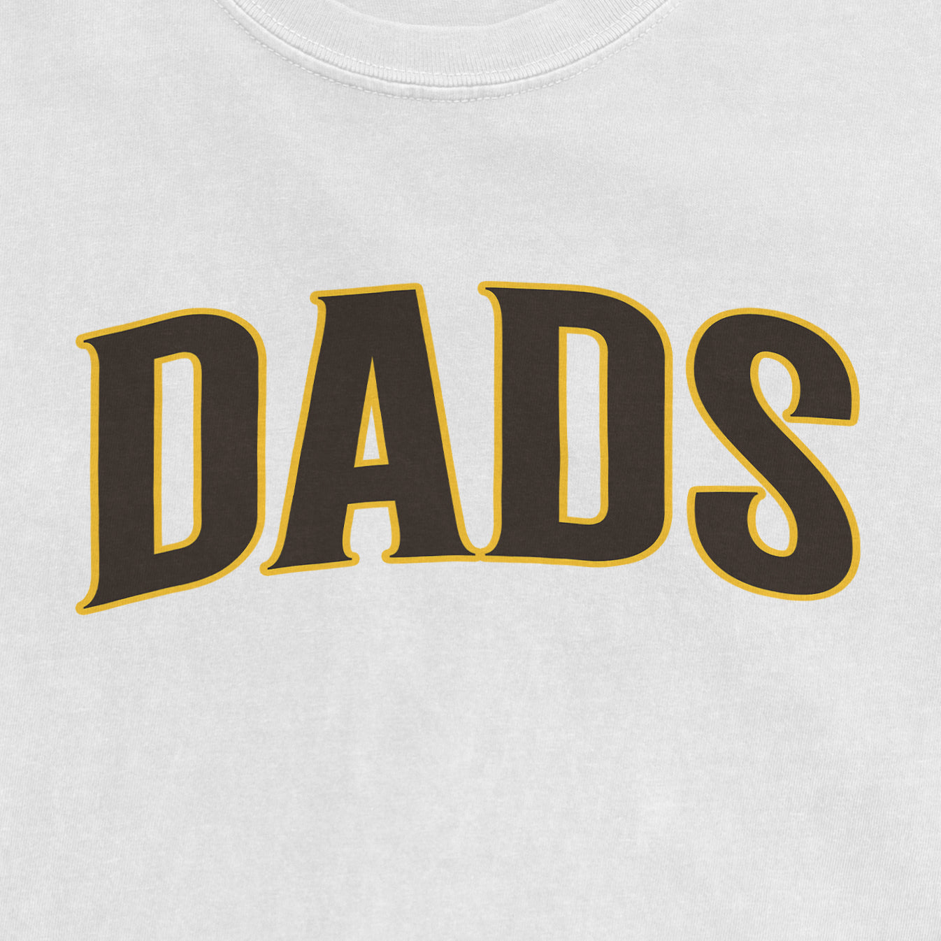 Close-up of a white T-shirt with the word "DADS" printed in bold, black letters outlined in yellow.