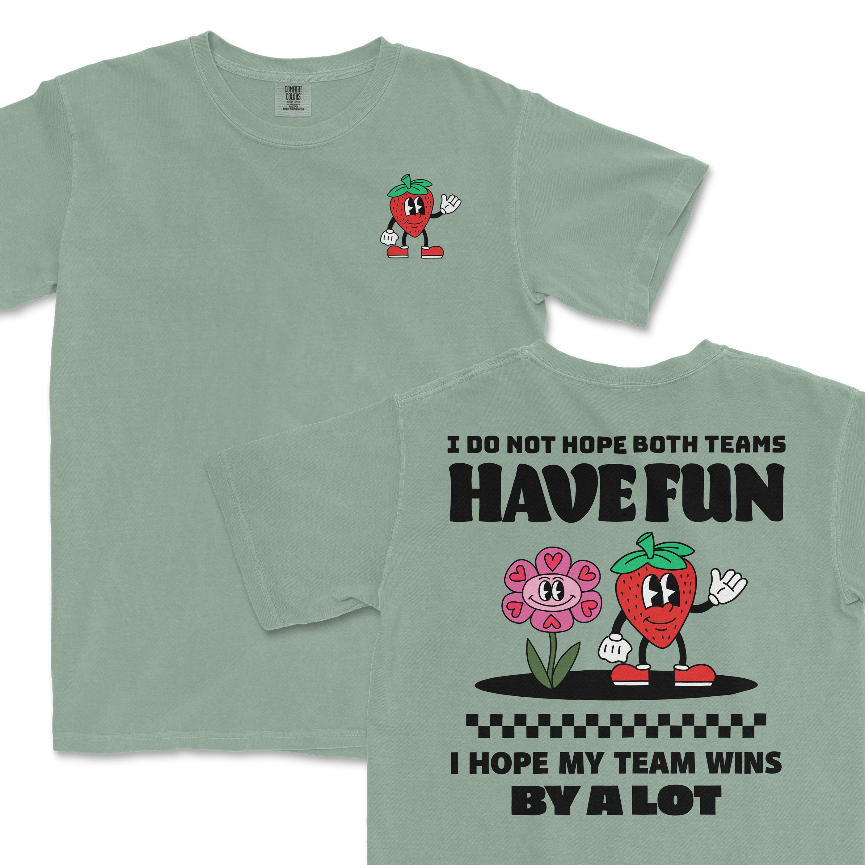 Light green Comfort Colors T-shirt featuring a cartoon strawberry character waving and a pink flower, with humorous text about team spirit.