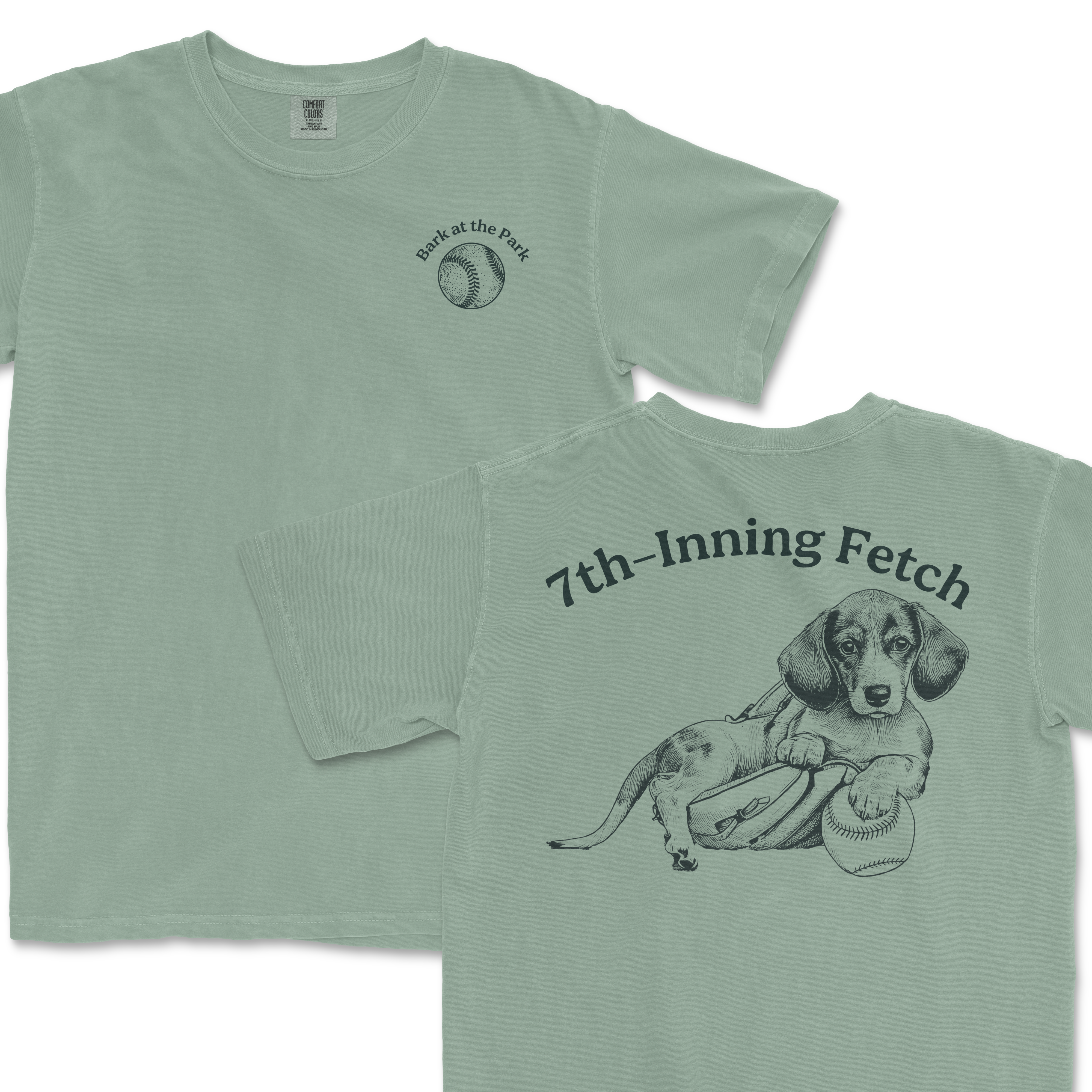 Light green Comfort Colors T-shirt featuring a Dachshund with a baseball, a glove, and the text "7th-Inning Fetch" on the back, and a baseball graphic with "Bark at the Park" on the front.