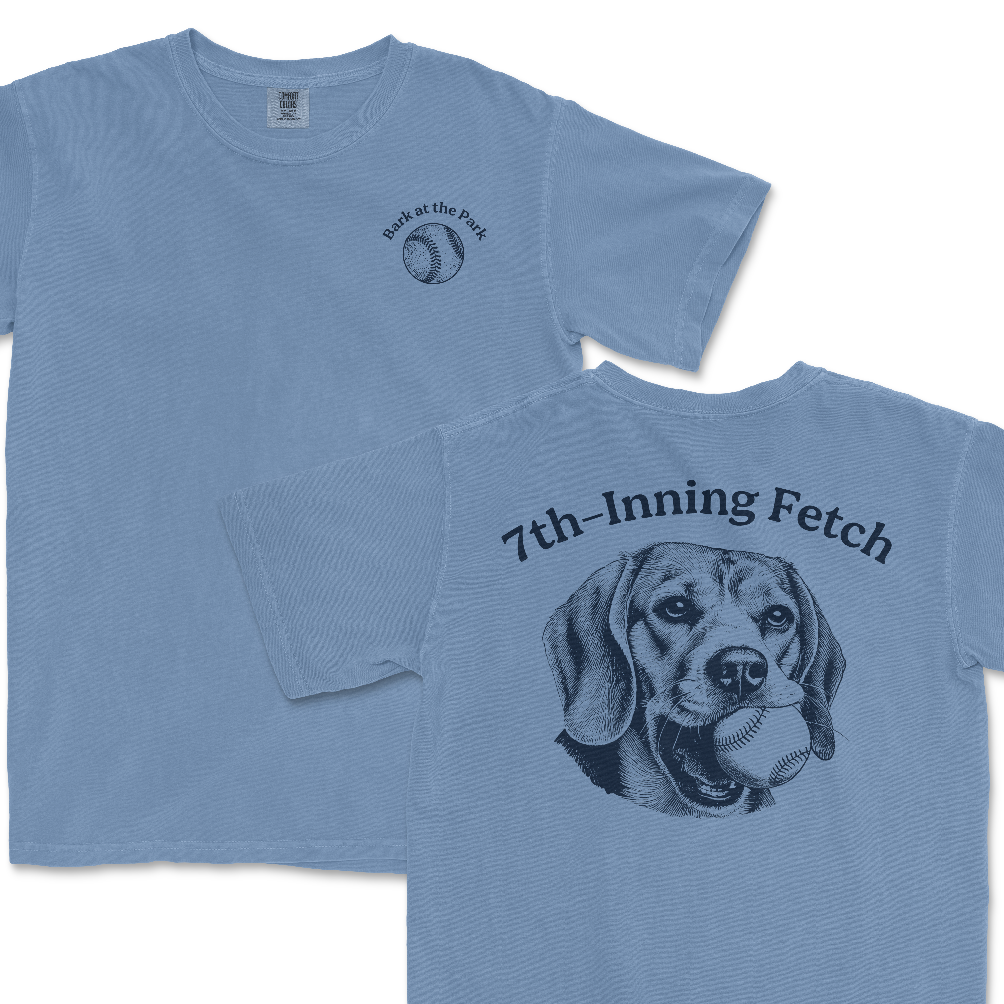 Light blue Comfort Colors T-shirt featuring a front small baseball graphic with "Bark at the Park" text and a large back illustration of a beagle dog holding a baseball in its mouth, with "7th-Inning Fetch" text above.