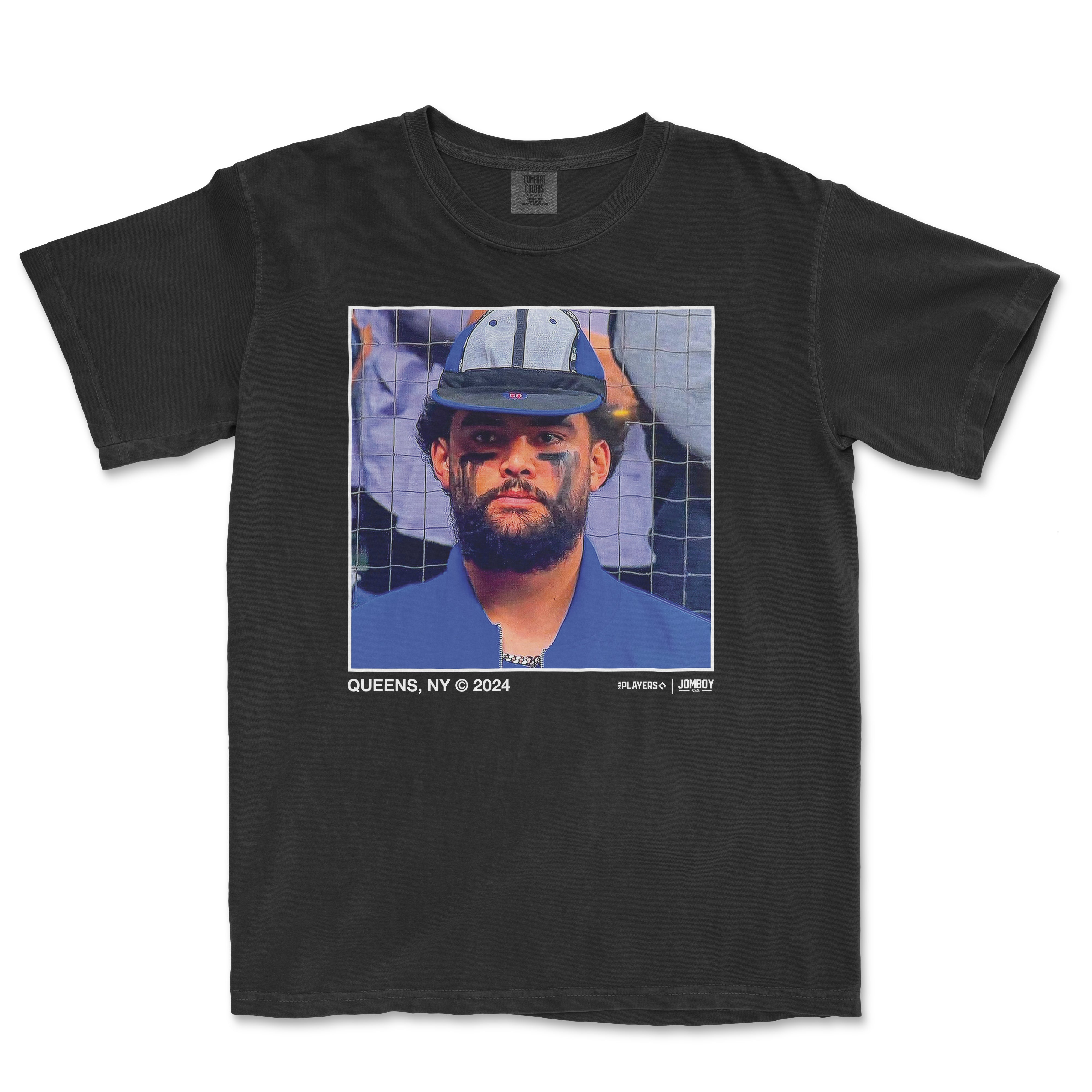 Black T-shirt featuring a portrait of Sean Manaea wearing a rally cap, with eye black and a serious expression, against a baseball net background.