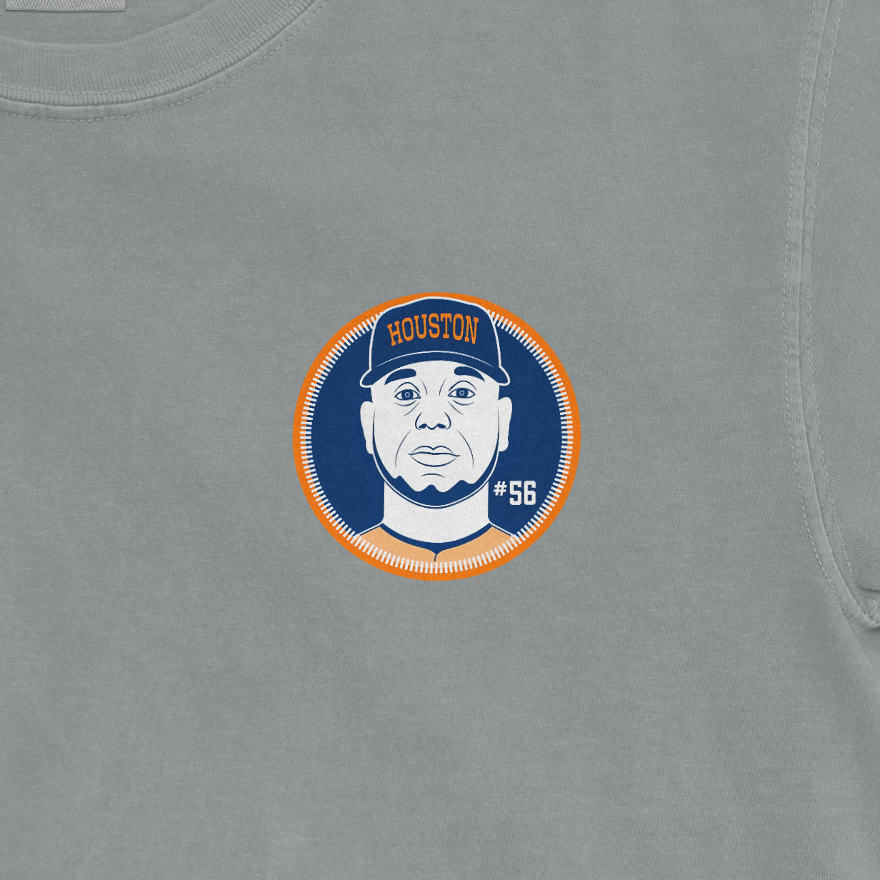 Close-up of a gray shirt featuring a circular graphic of a man wearing a Houston cap, with the number 56 on the right side.