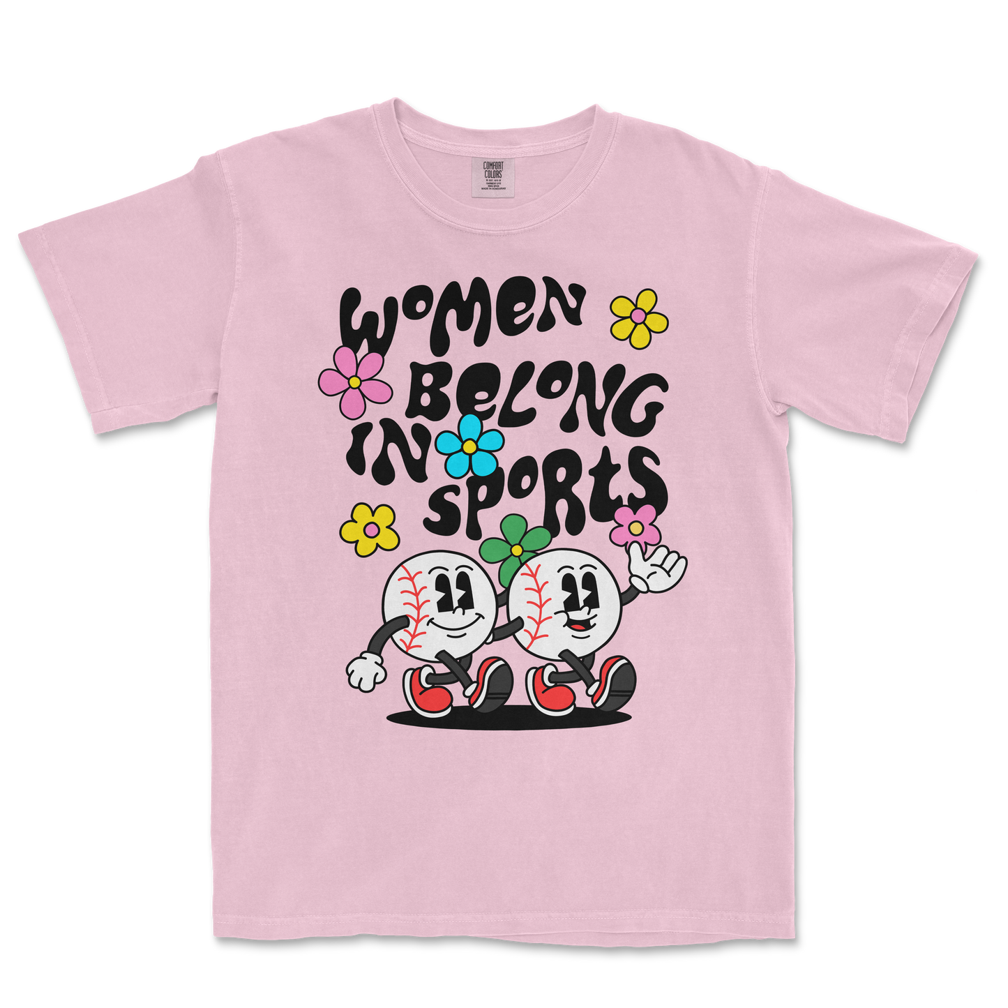 Pink T-shirt featuring cartoon baseballs with smiling faces, flowers, and the text "Women Belong in Sports" in bold black letters.