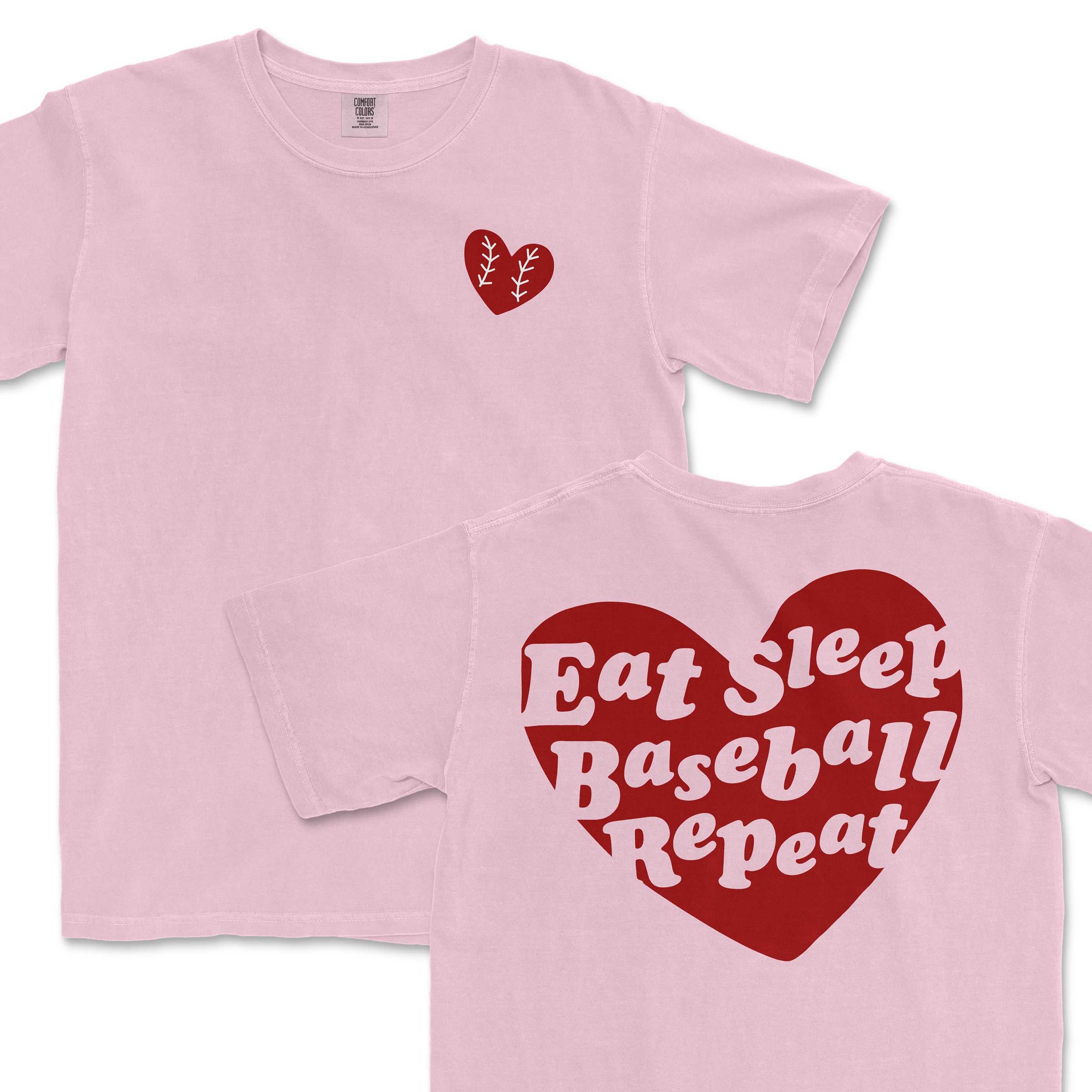 Pink Comfort Colors T-shirt with "Eat Sleep Baseball Repeat" text inside a large red heart on the back and a small red heart on the front.