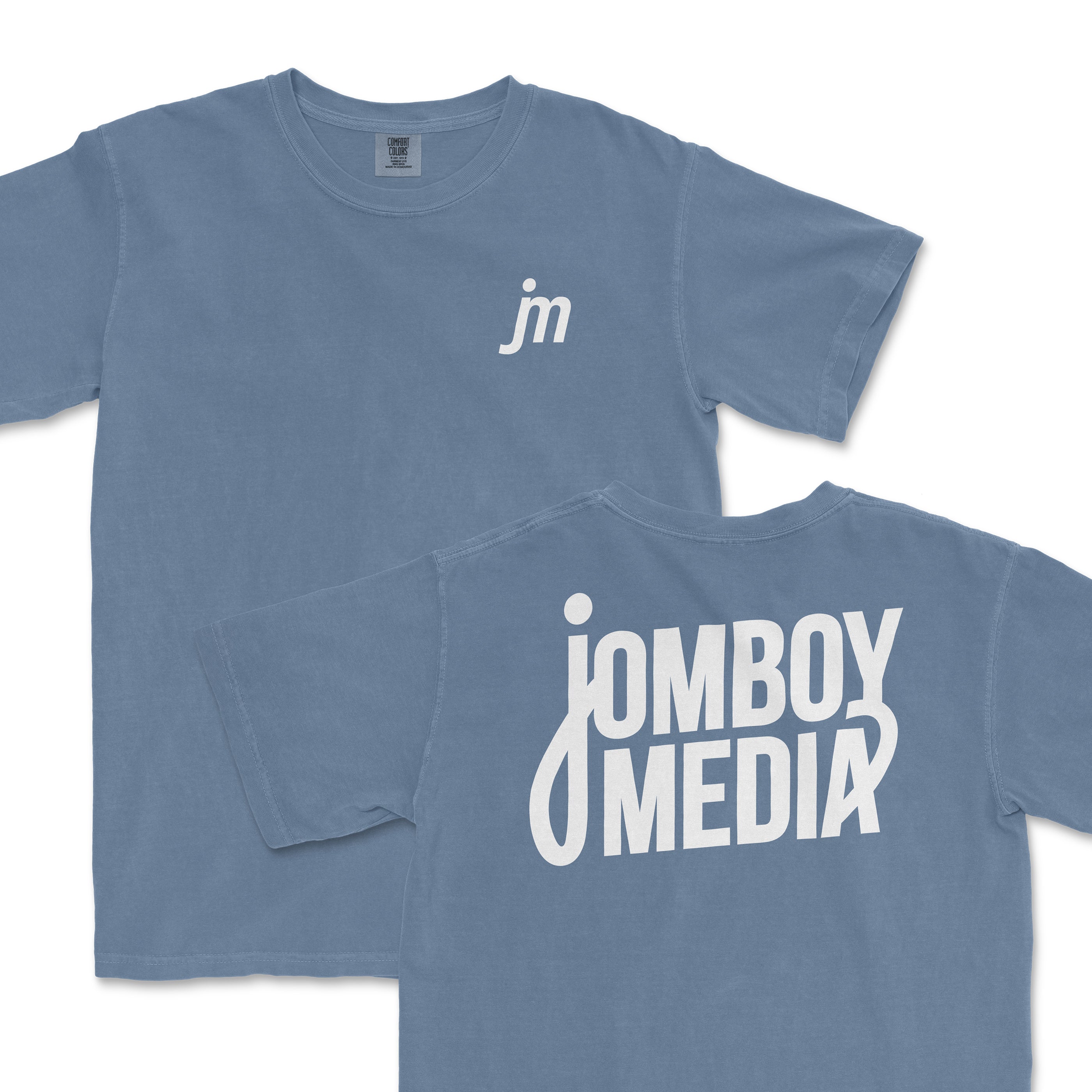 JM Essentials '25 Logo Tee in blue featuring a small logo on the front and bold text on the back. Ideal for sports fans.