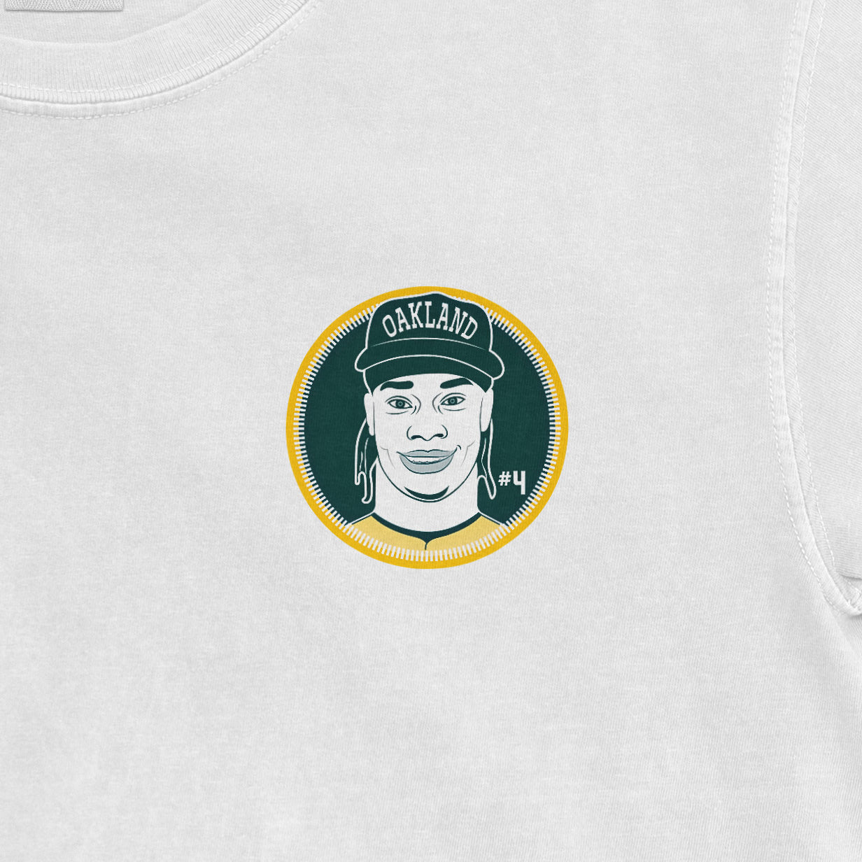 Close-up of a white Comfort Colors T-shirt featuring a graphic of Lawrence Butler with "Oakland" cap and "#4" on a circular background.