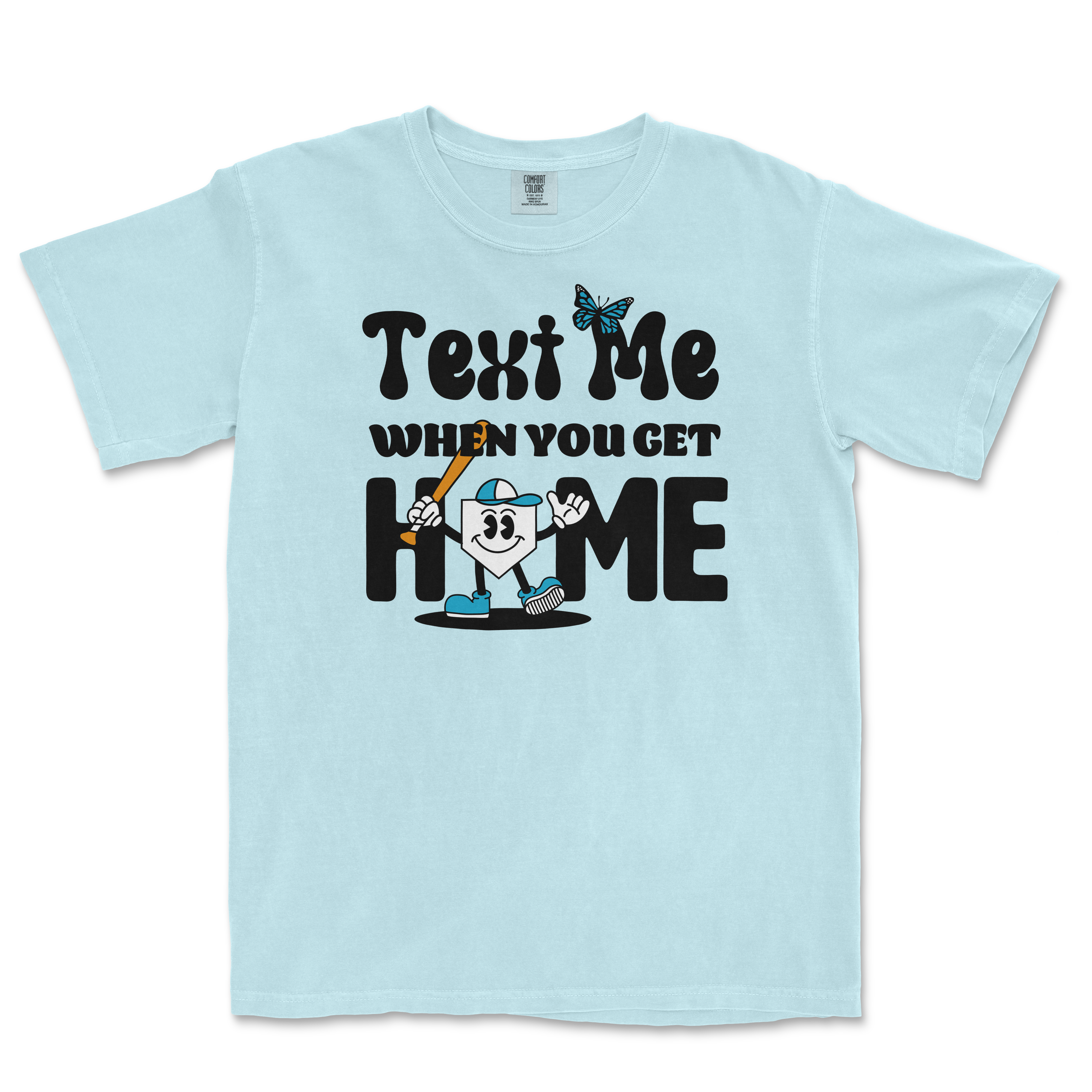 Light blue T-shirt with a cartoon character holding a bat, and text that reads "Text Me When You Get Home" in playful black font.