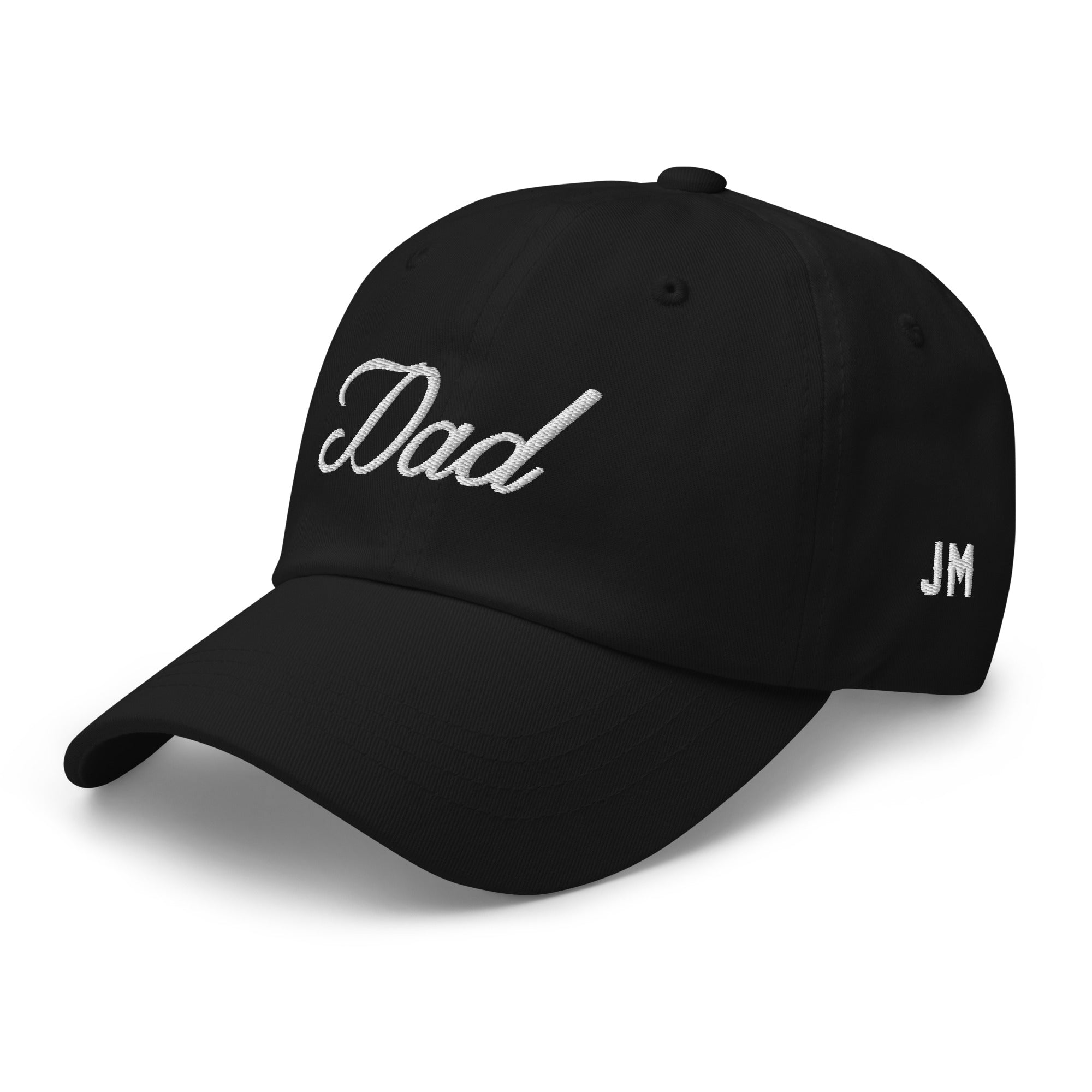 Black dad hat with white embroidered "Dad" on front and "JM" on side, featuring a curved brim and adjustable strap.