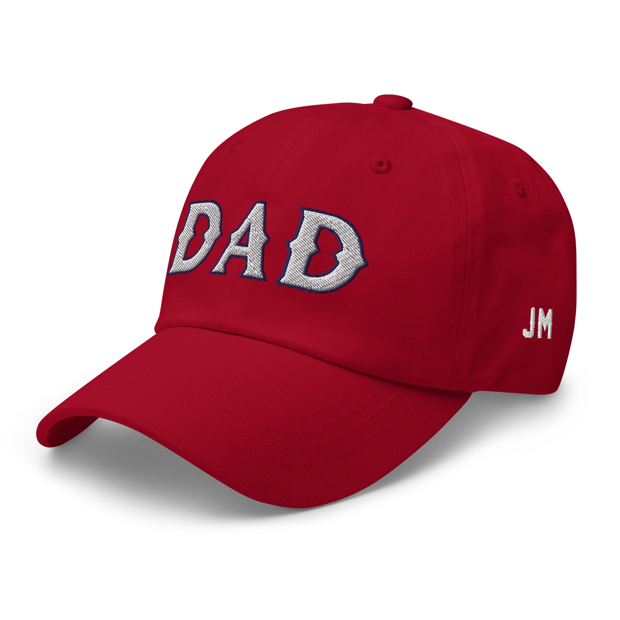 Red dad hat with "DAD" embroidered in large silver letters on the front and "JM" initials on the side.