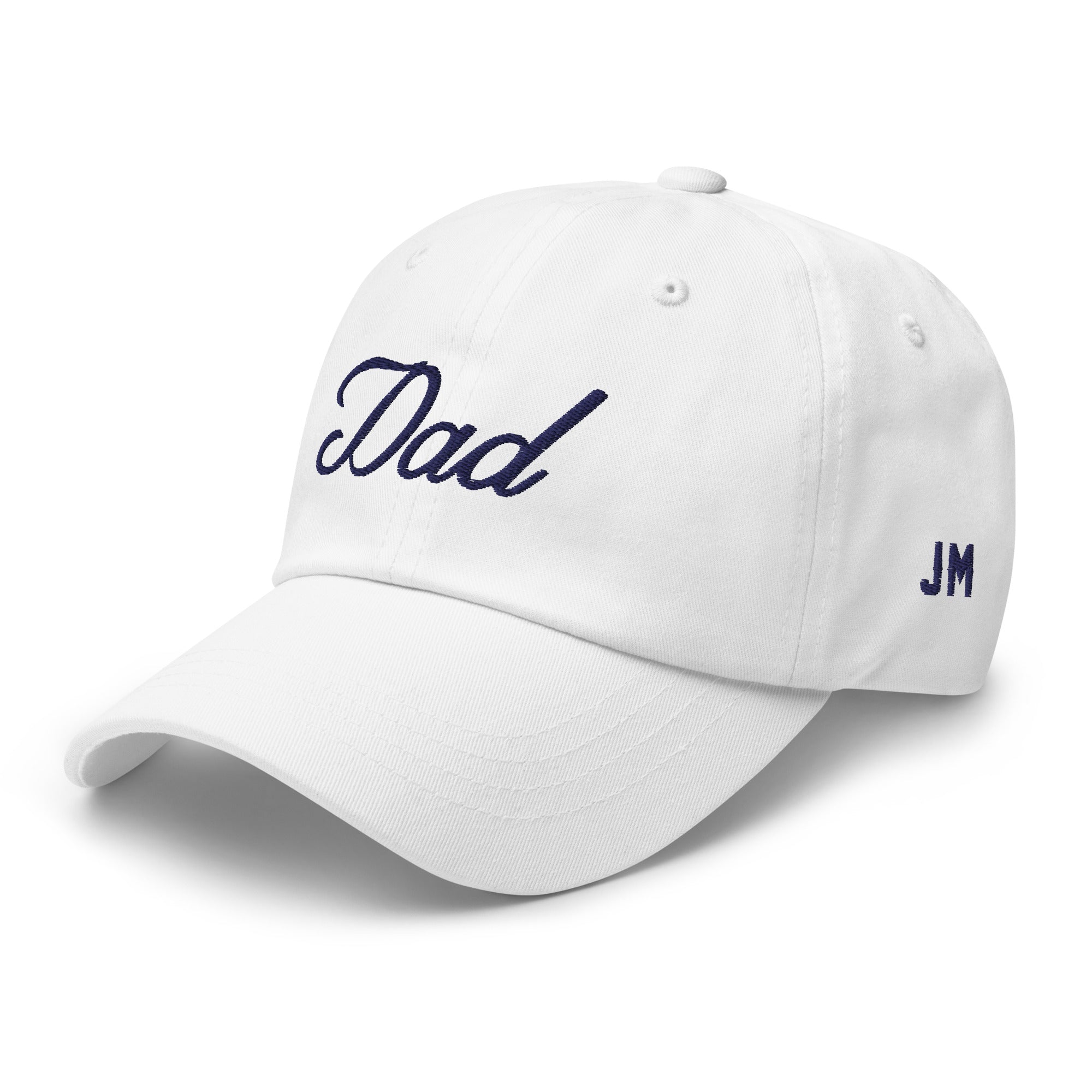 White dad hat with "Dad" embroidered in navy blue on the front and "JM" on the side, featuring a curved brim and adjustable strap.