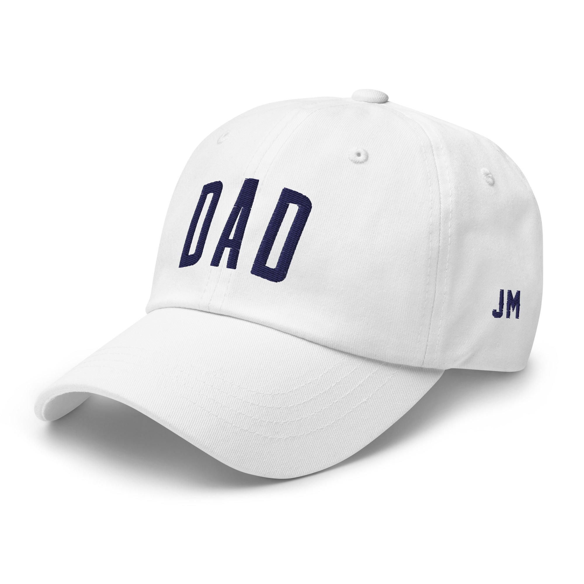 White dad hat with "DAD" embroidered in navy blue on the front and "JM" on the side, featuring a curved brim and adjustable strap.