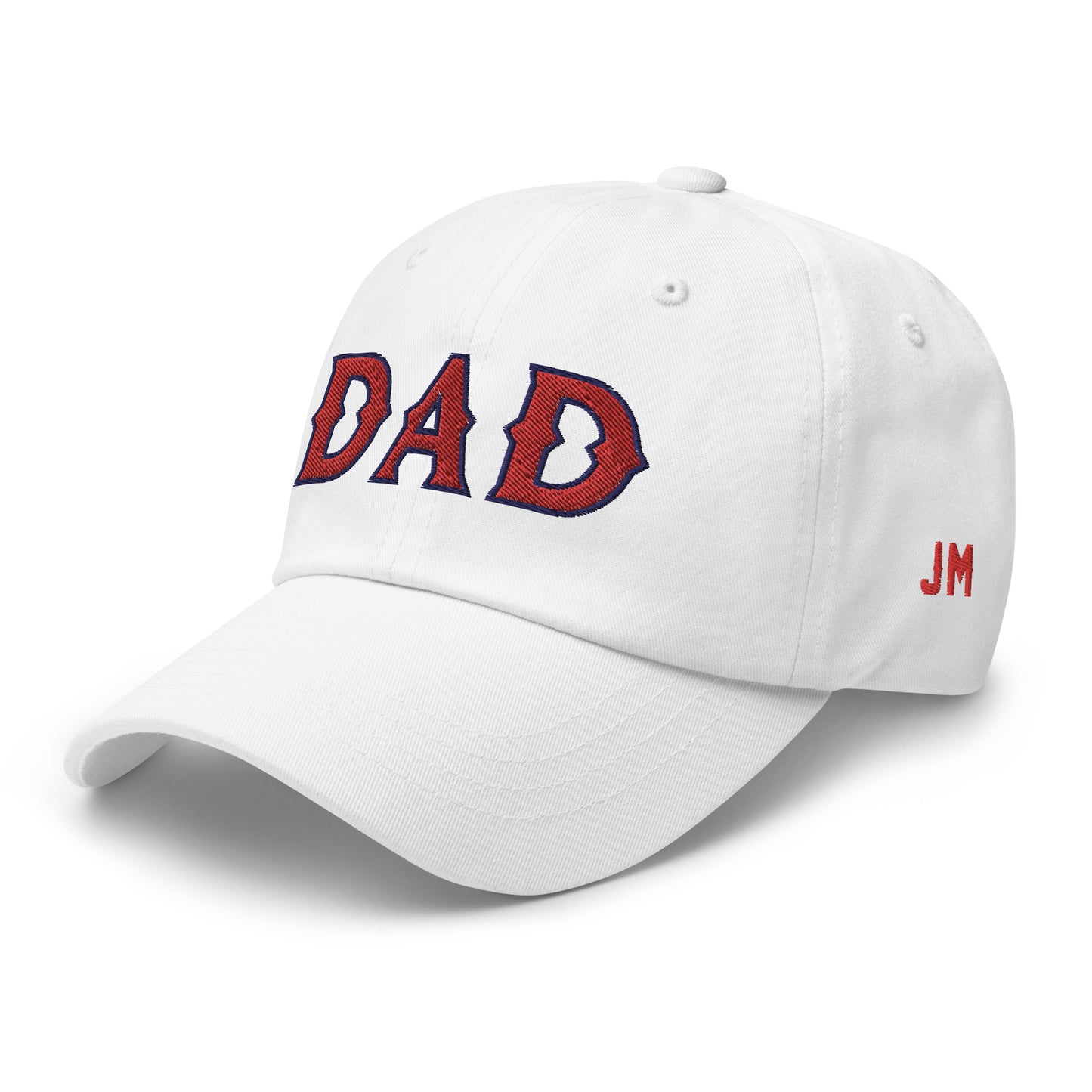 White dad hat with "DAD" embroidered in red and navy on the front, and "JM" embroidered in red on the side.