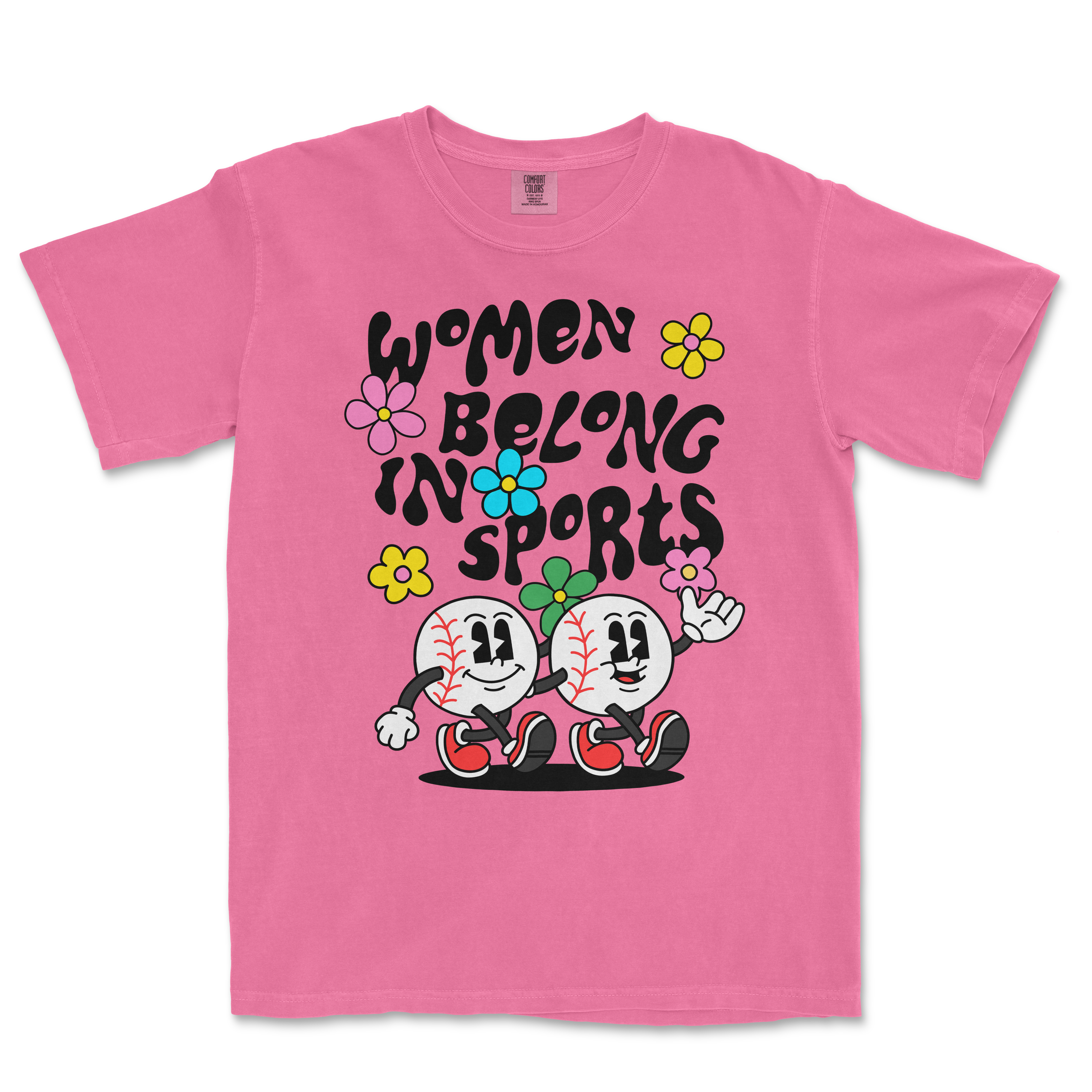 Pink T-shirt with cartoon baseball characters, colorful flowers, and the text "Women Belong in Sports" in bold black letters.