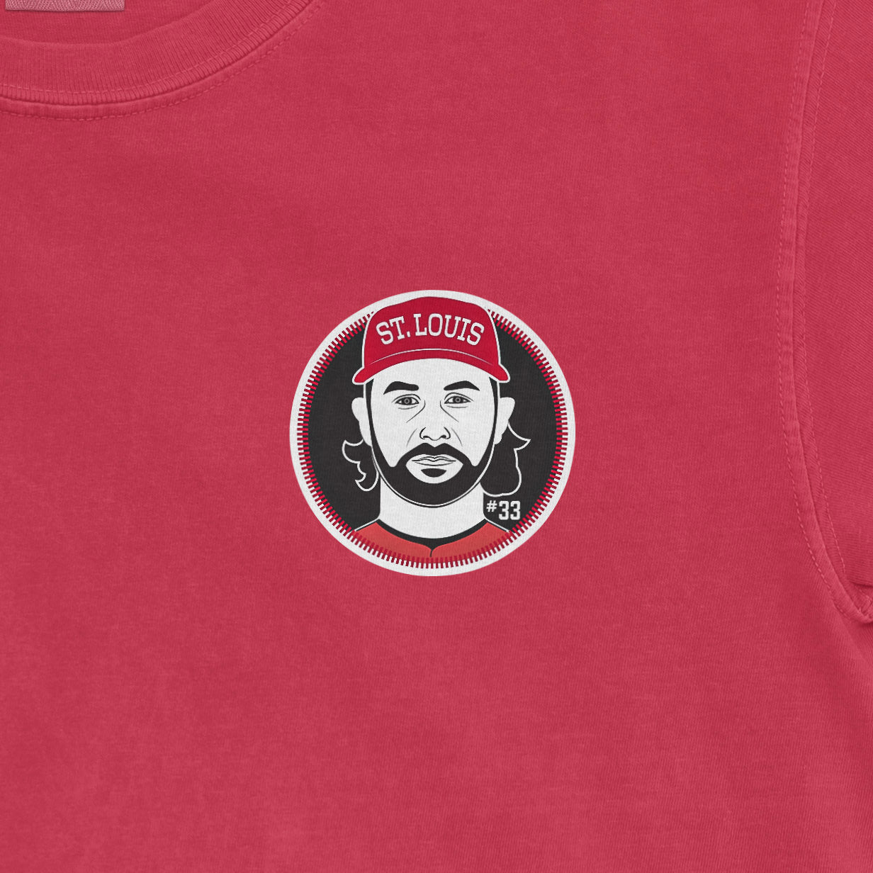Close-up of a red Comfort Colors T-shirt featuring a graphic of Brendan Donovan with "St. Louis" and "#33" on a cap.