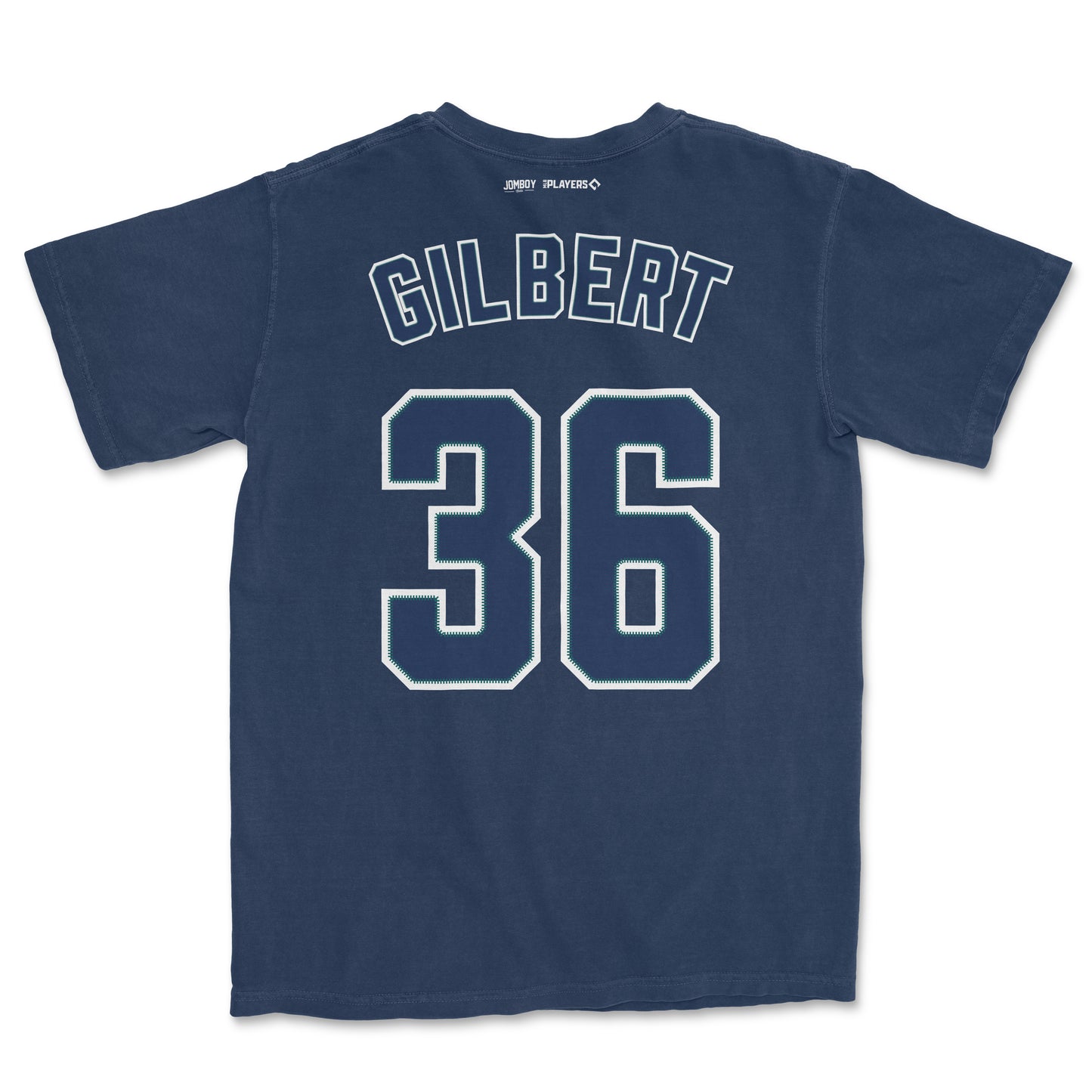 Back of navy blue Comfort Colors tee featuring "Gilbert" and the number "36" in white with green accents, and small brand logos at the top.