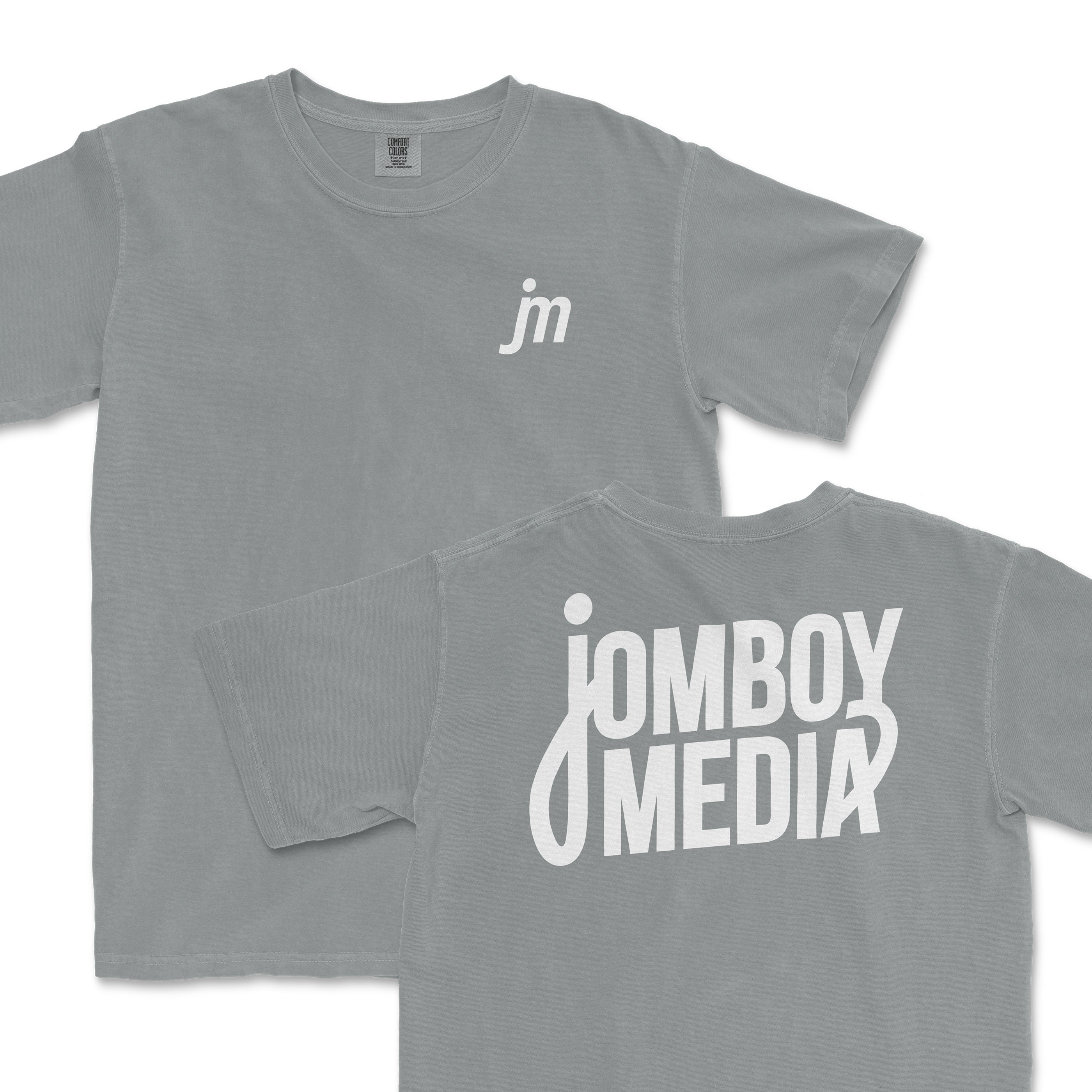 Gray JM Essentials '25 Logo Tee featuring a small logo on the front and bold Jomboy Media text on the back.