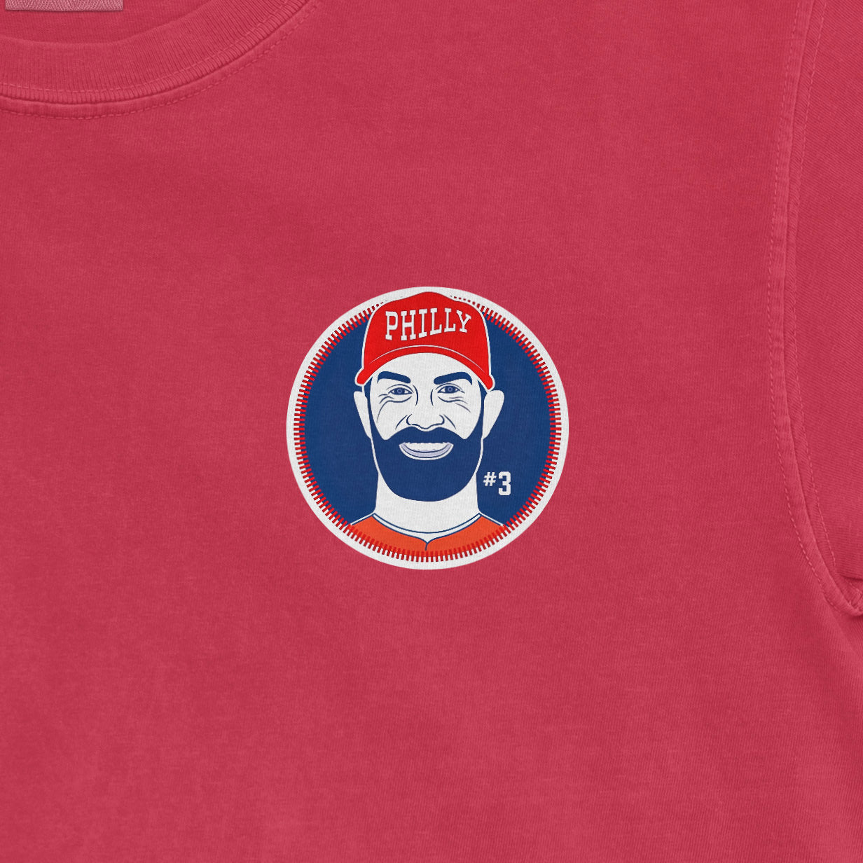 Bryce Harper Phillies graphic on a Comfort Colors red t-shirt featuring his face, beard, #3, and a red Phillies cap.