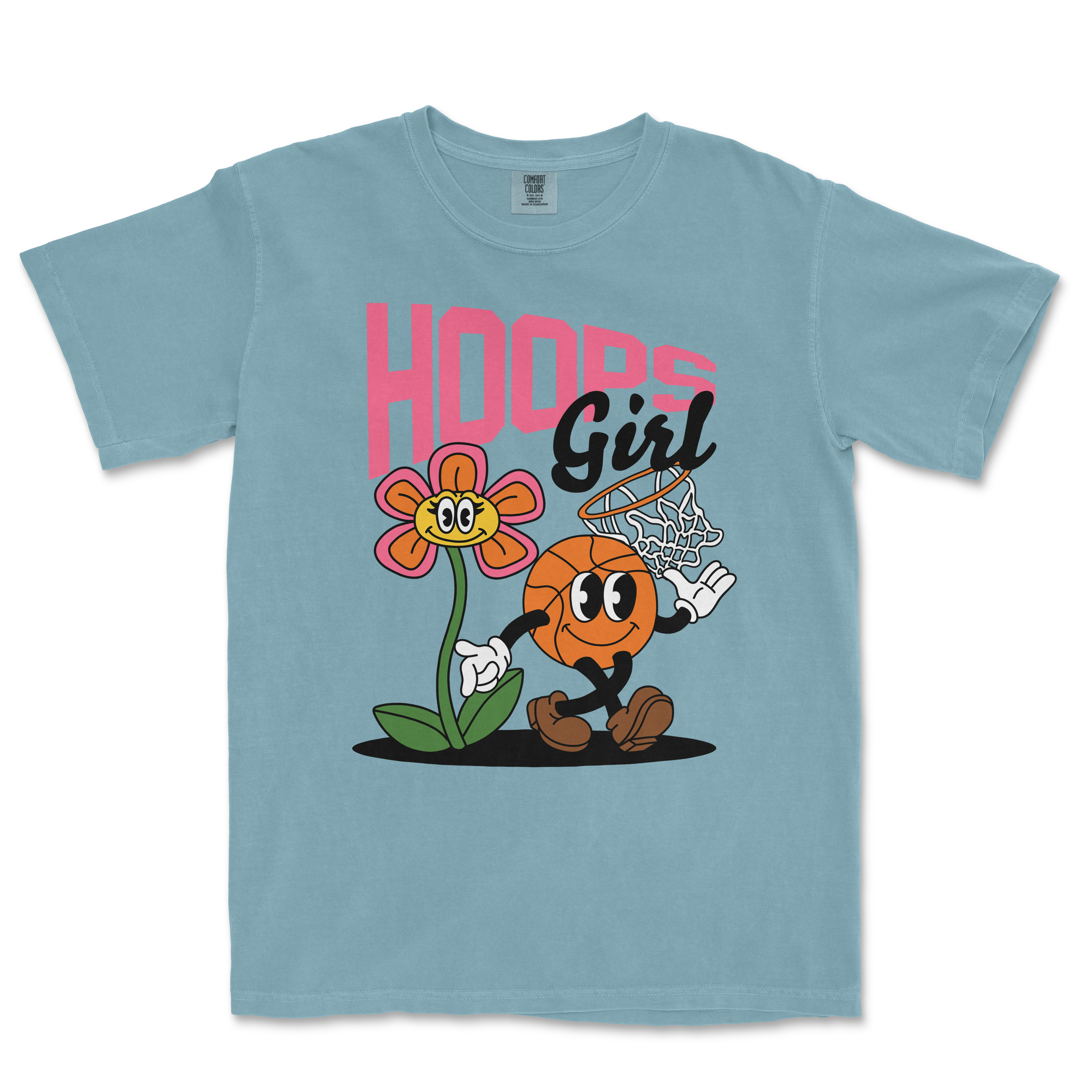 Light blue Comfort Colors T-shirt featuring a cartoon basketball character playing basketball next to a smiling flower, with "Hoops Girl" text.