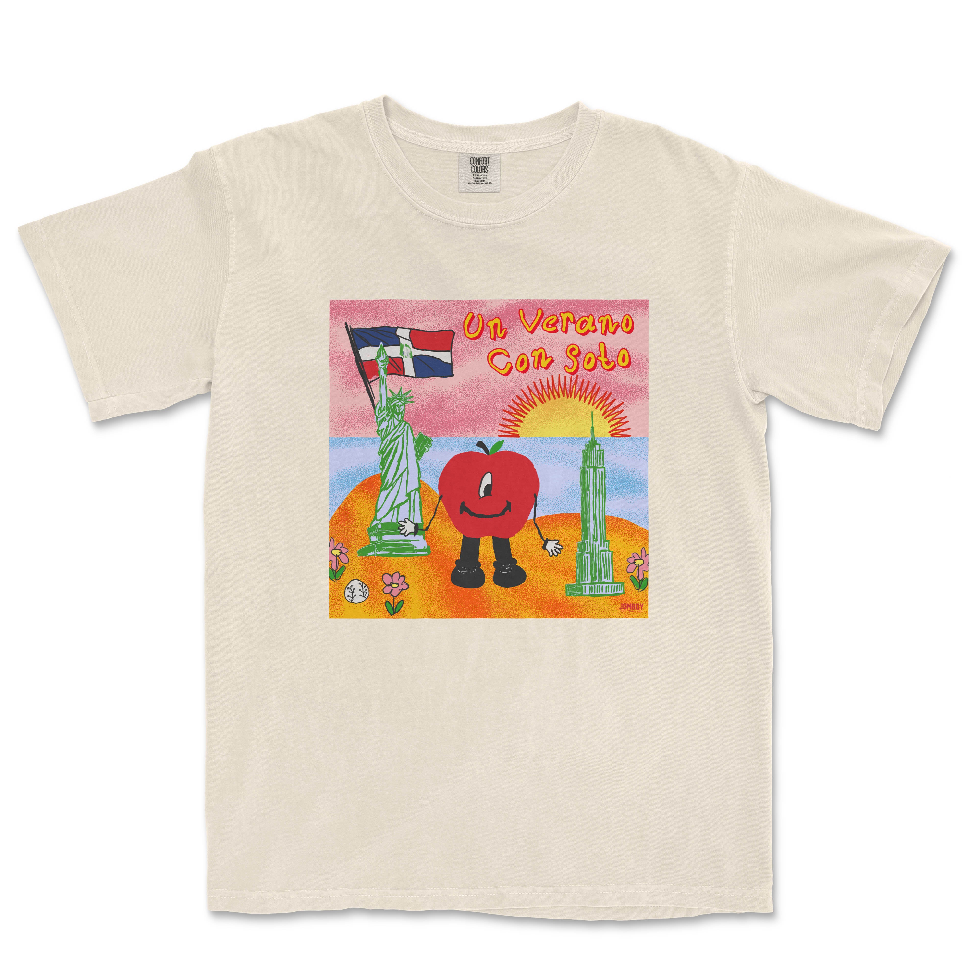 T-shirt featuring a colorful cartoon illustration of a tomato character holding a French flag, with landmarks, a sunset, and the text "Un Verano Con Soto.