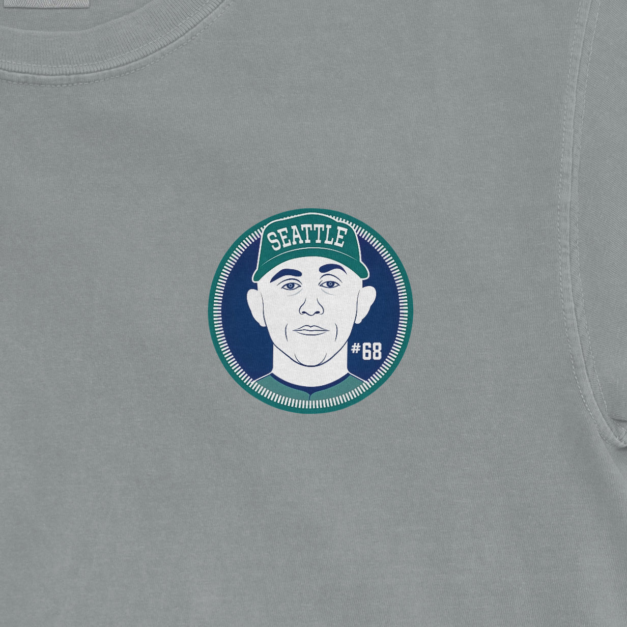 Close-up of a Comfort Colors tee featuring a graphic of George Kirby with "Seattle" and "#68" on a circular badge.