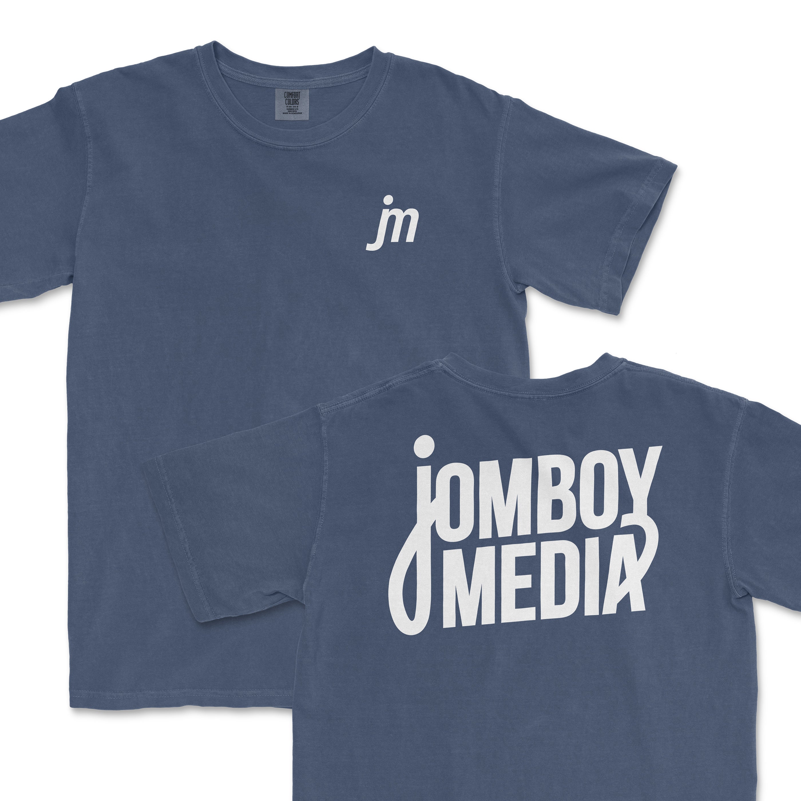 JM Essentials '25 Logo Tee in navy blue featuring a small logo on the front and bold Jomboy Media text on the back.
