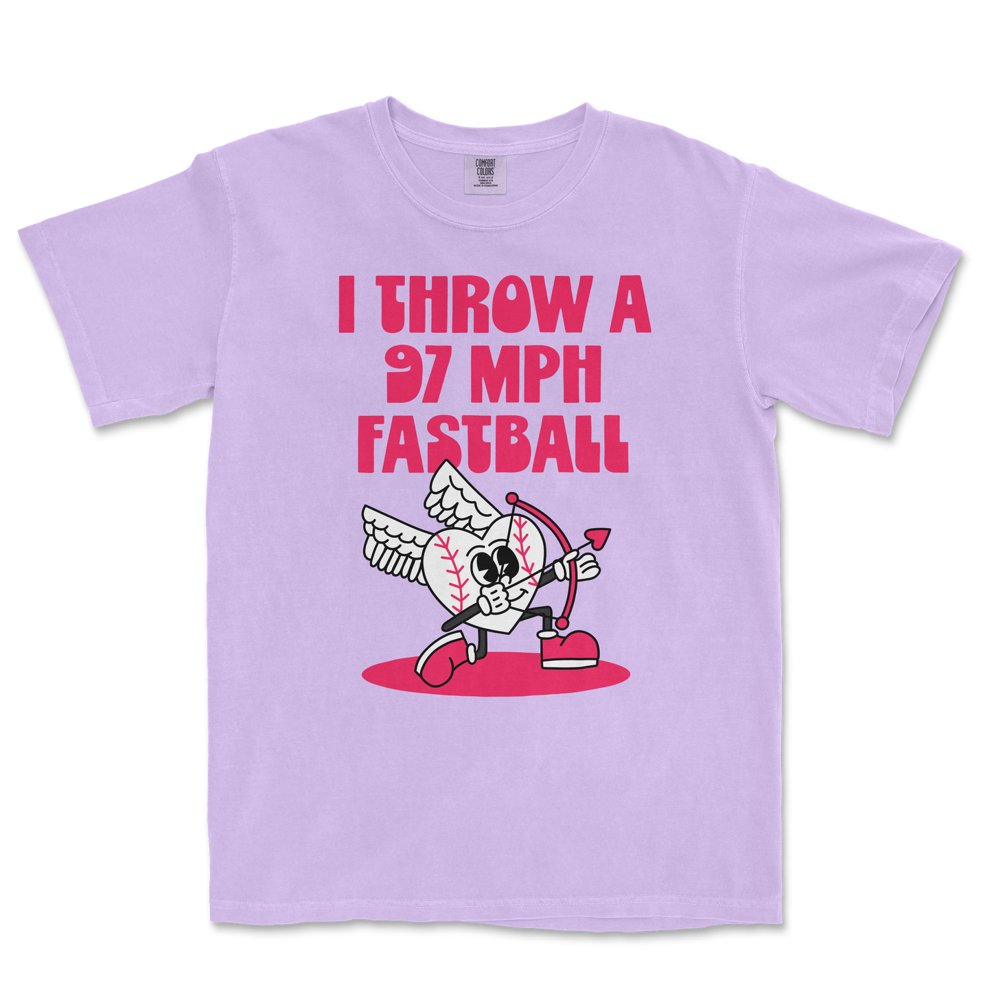 Lavender Comfort Colors T-shirt featuring a cartoon baseball with wings, holding a bow, with bold pink text: "I THROW A 97 MPH FASTBALL.