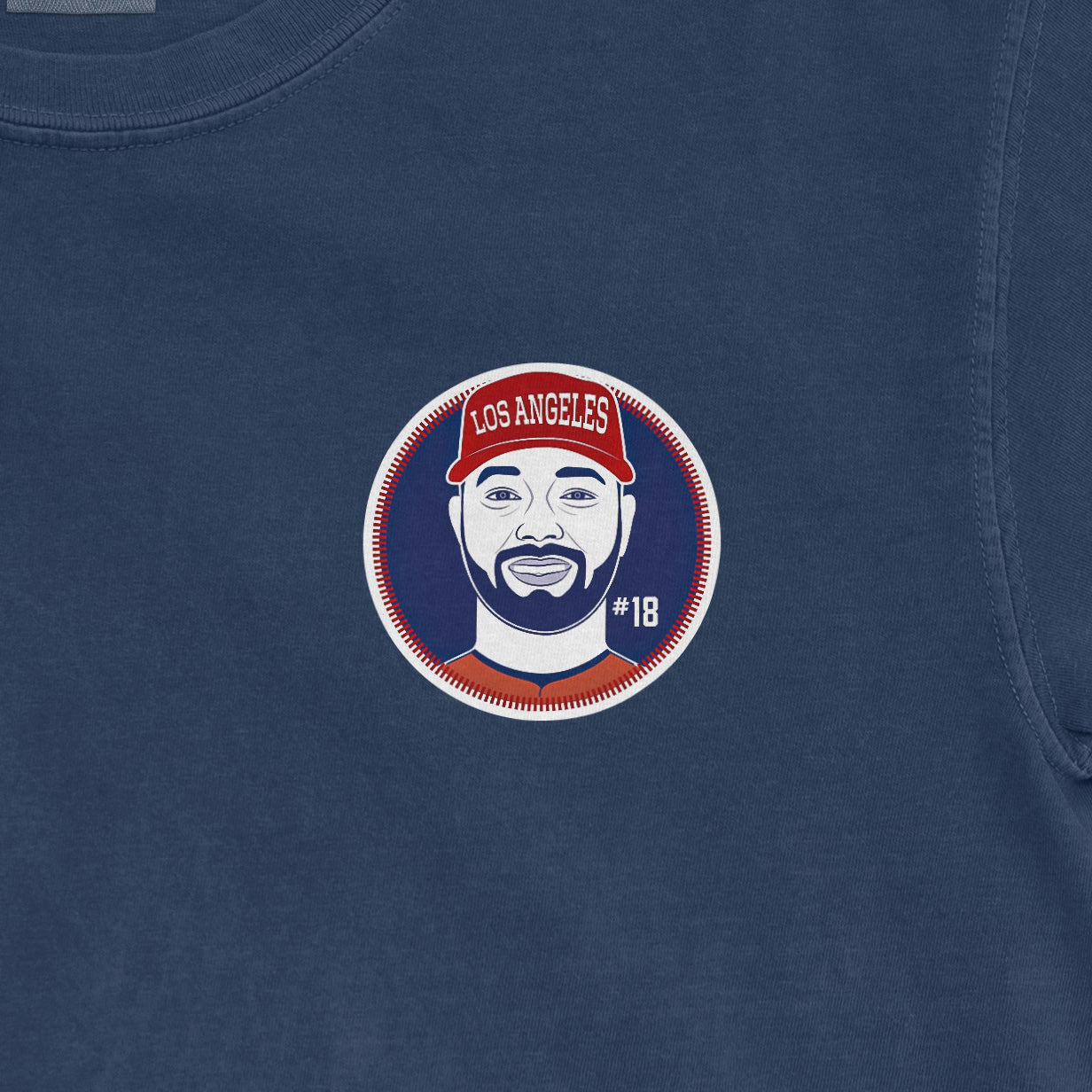 Blue Comfort Colors tee featuring a Nolan Schanuel Los Angeles baseball graphic with #18 and a red cap.