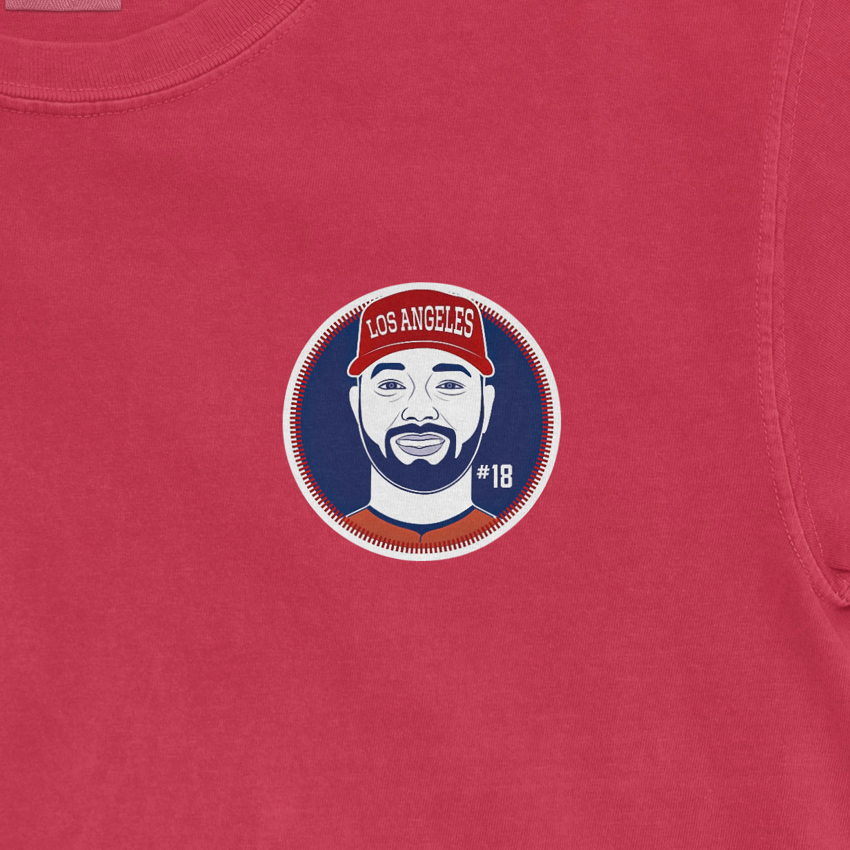 Comfort Colors tee featuring a graphic of Nolan Schanuel with a Los Angeles cap, #18, on a pink background.