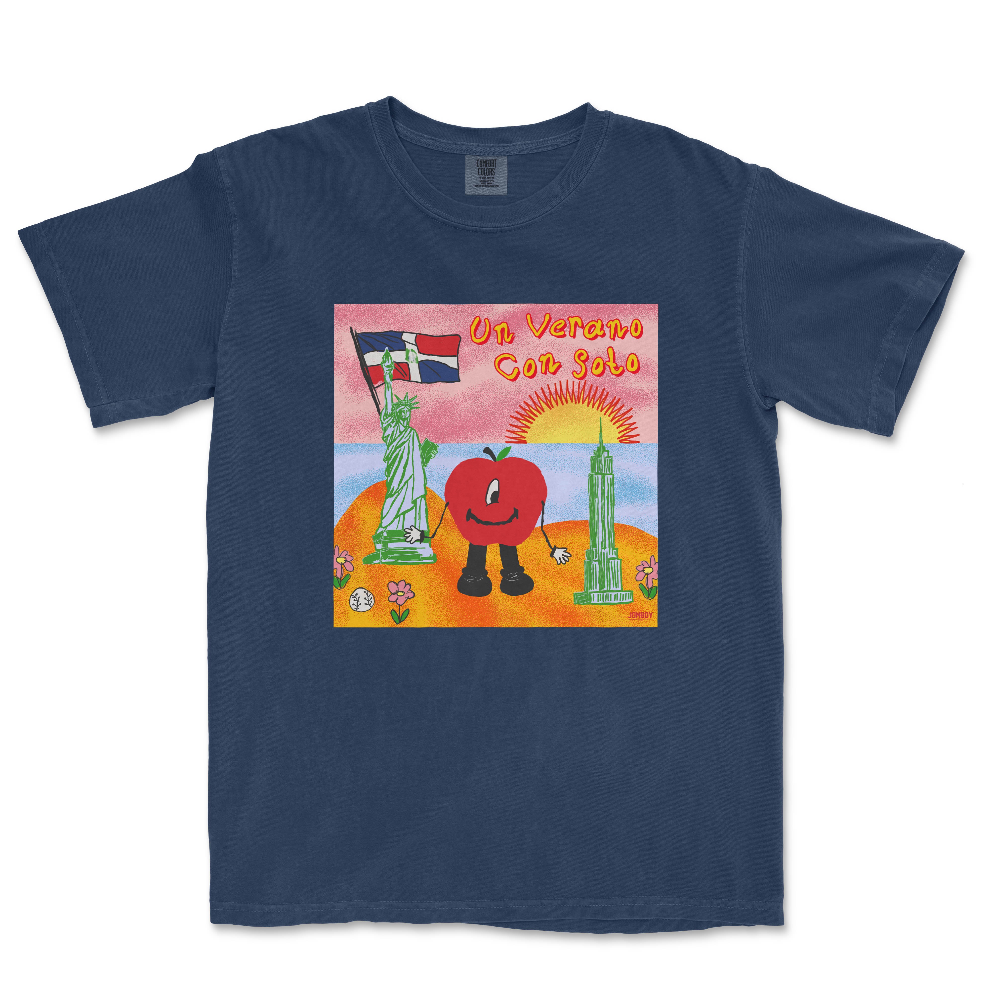 A navy blue T-shirt featuring a colorful cartoon design with a smiling tomato character, the Statue of Liberty, a sunset, and the text "Un Verano Con Soto.