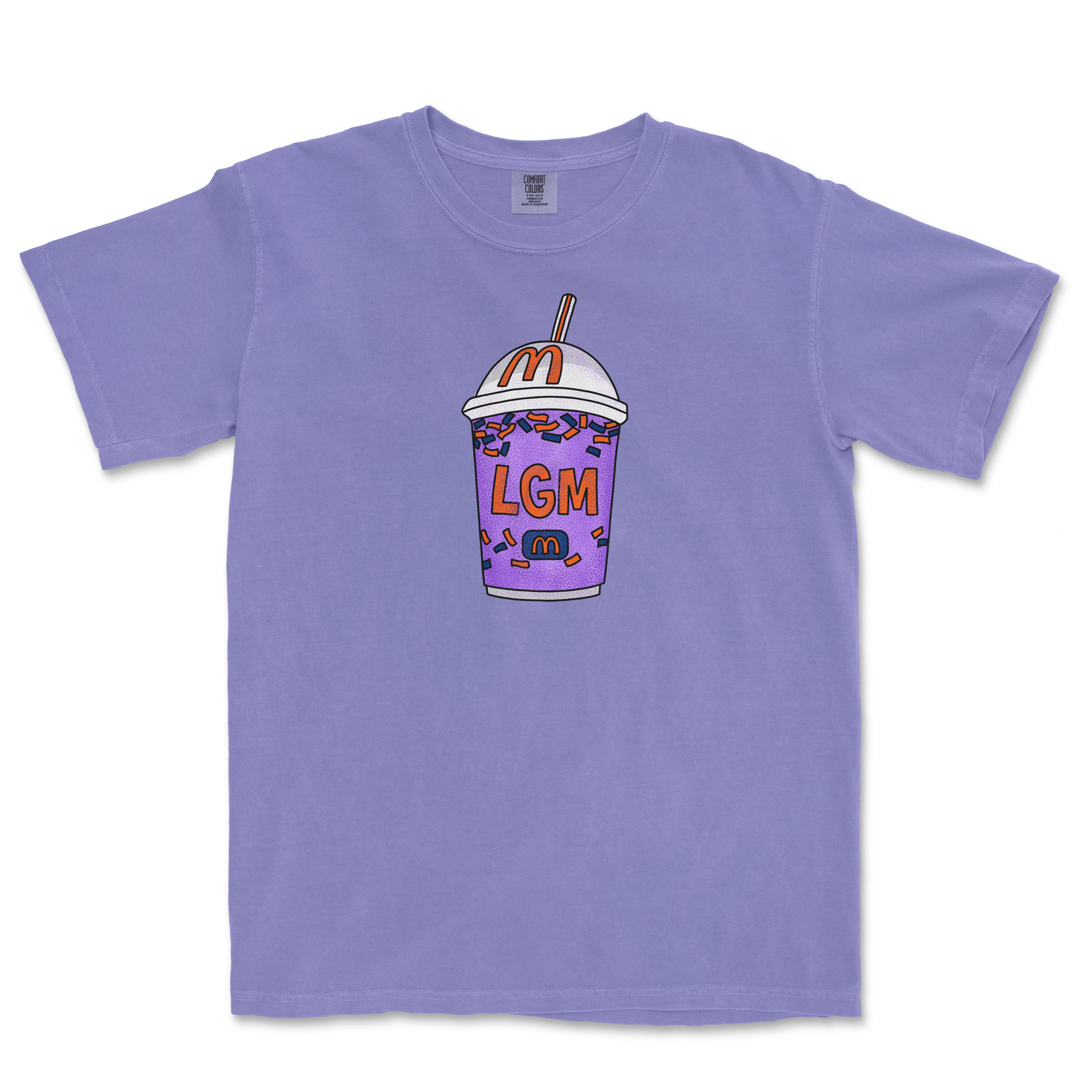 Purple T-shirt featuring a colorful, cartoon-style milkshake with sprinkles, a straw, and "LGM" text on the front.