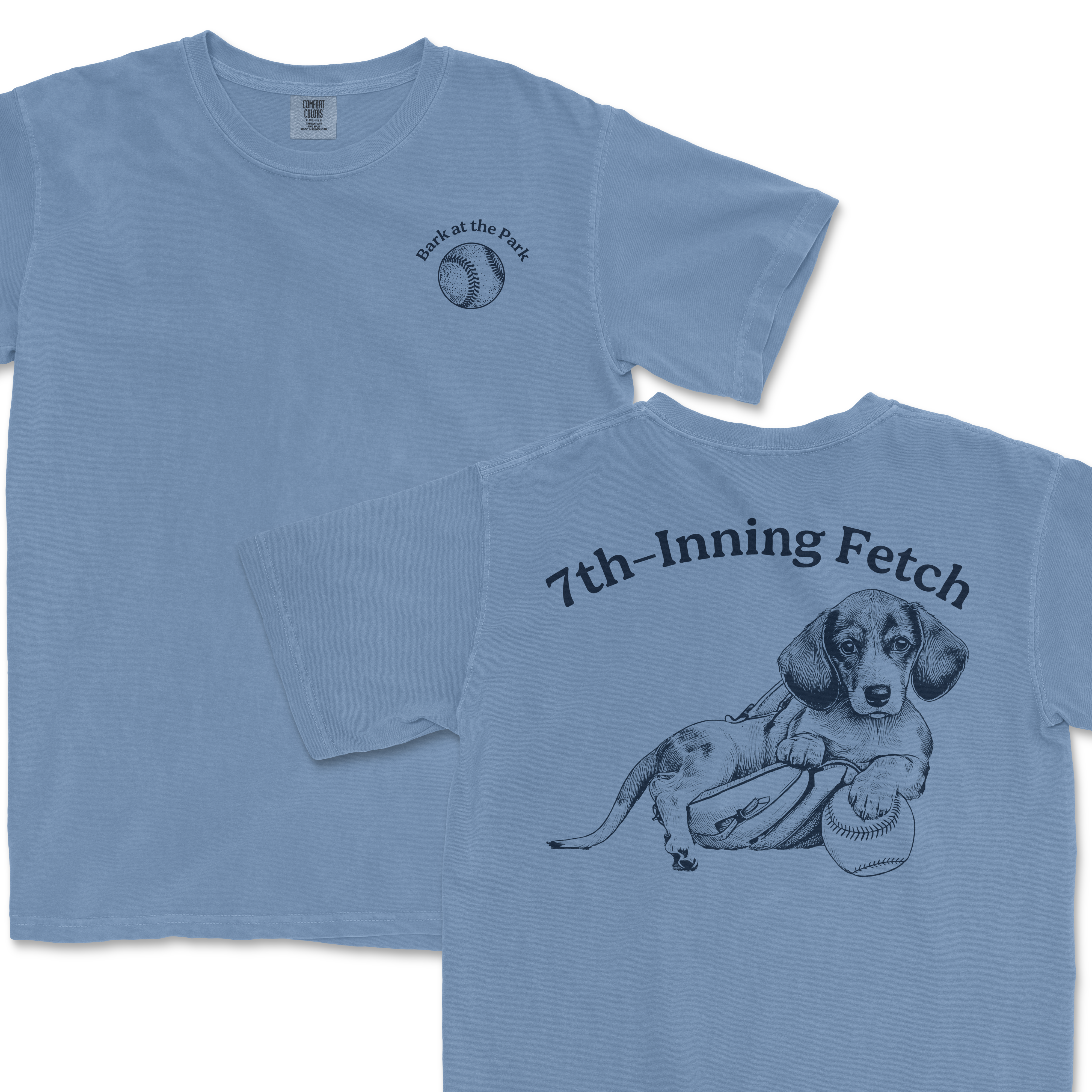 Light blue Comfort Colors T-shirt featuring a Dachshund with a baseball, football, and the text "7th-Inning Fetch" on the back and a baseball graphic with "Bark at the Park" on the front.