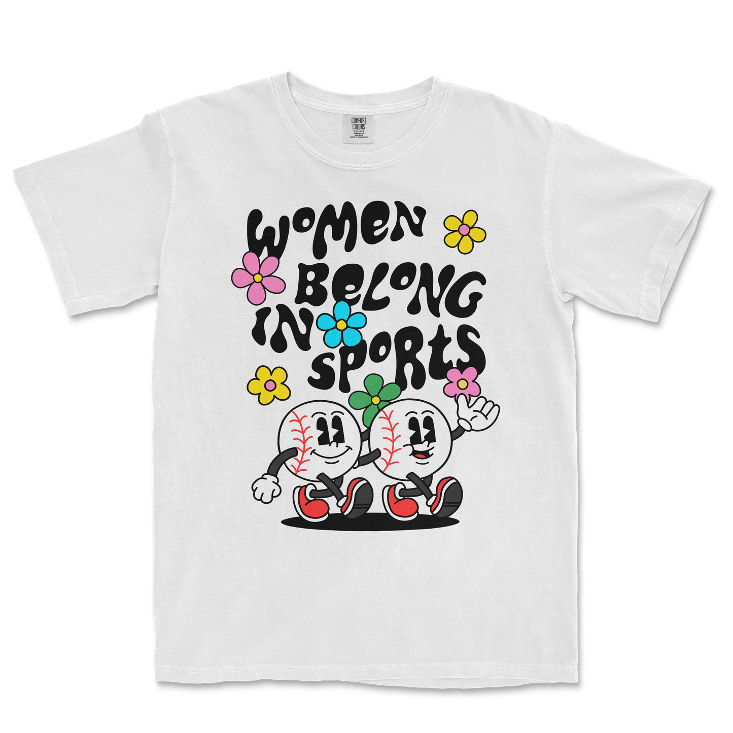 White T-shirt with colorful cartoon baseball characters and flowers, featuring the text "Women Belong in Sports" in bold black letters.