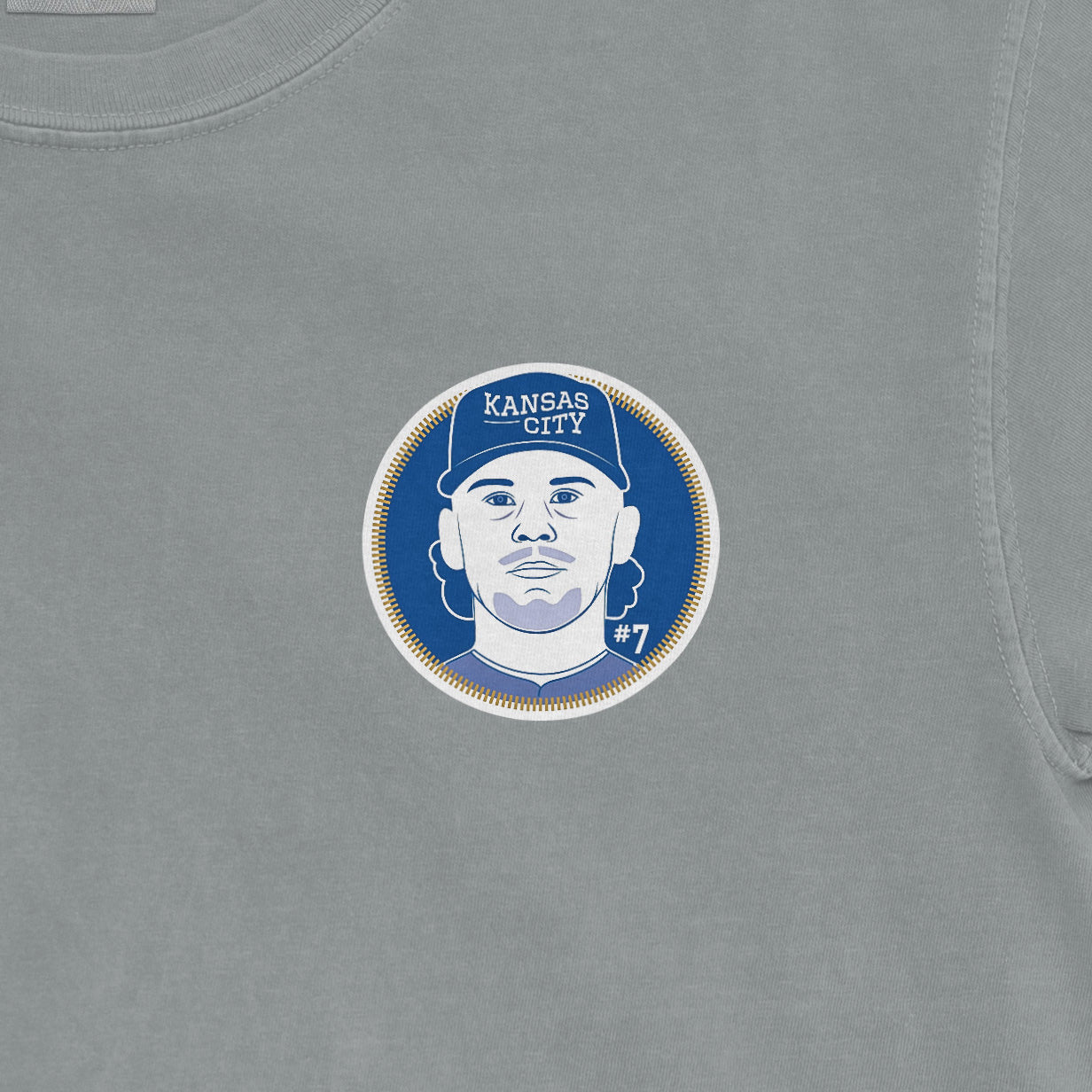 Close-up of a Comfort Colors tee featuring a Bobby Witt Jr. Kansas City Royals graphic with his portrait, team name, and jersey number.