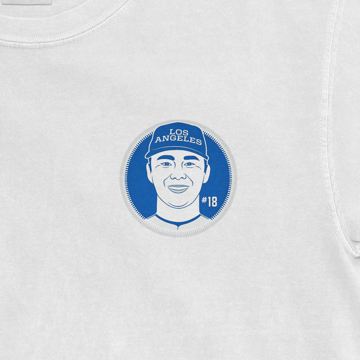 White shirt featuring a blue circular illustration of Yoshinobu Yamamoto with "LOS ANGELES" and "#18" text.