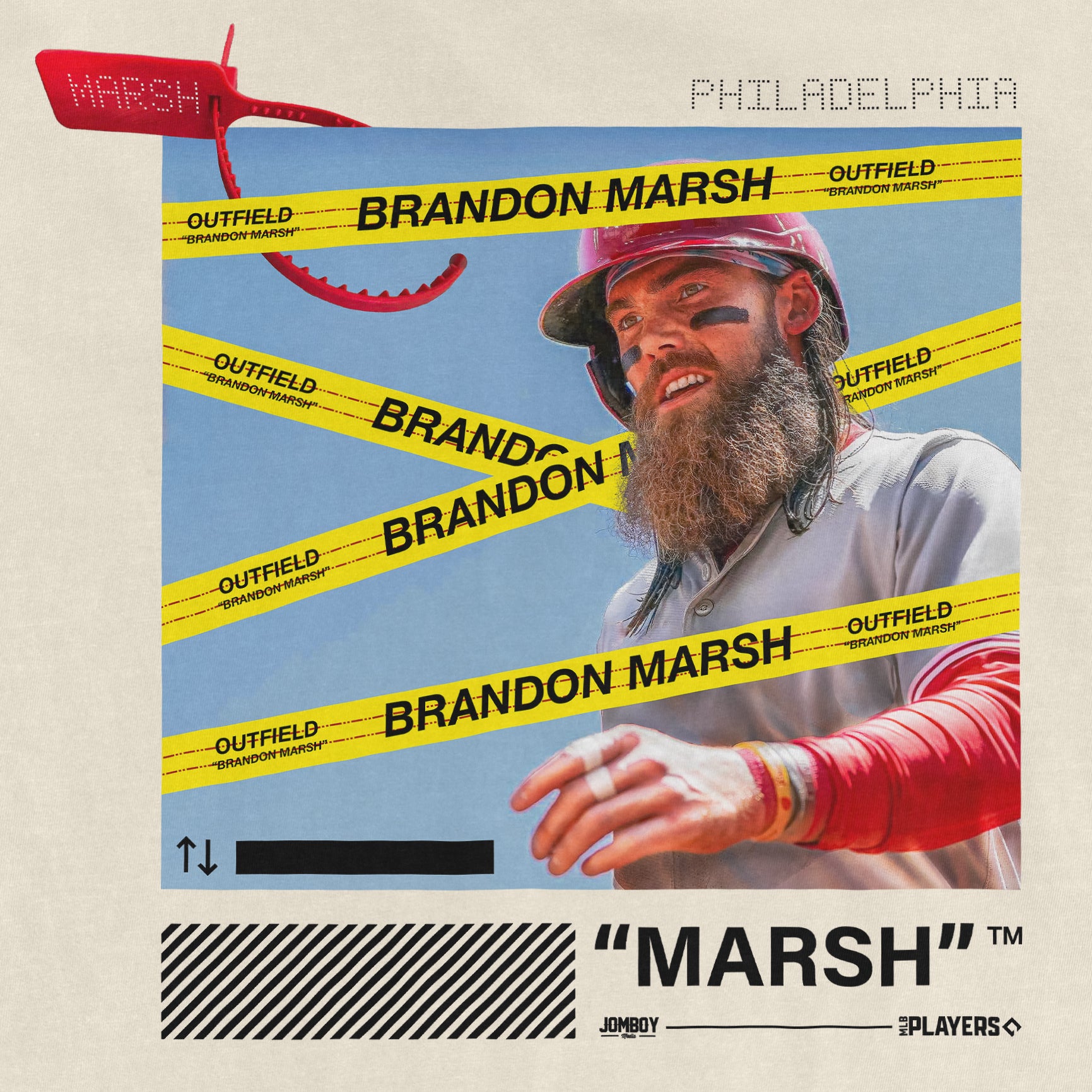 Close-up of a graphic T-shirt featuring a bearded man in a helmet, with yellow "Brandon Marsh" and "Outfield" tape overlays, and black text on the bottom reading '"Marsh" TM.