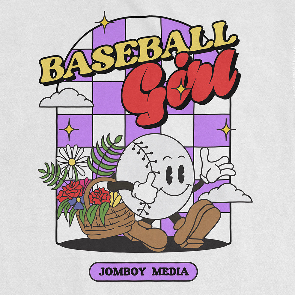 Comfort Colors tee featuring a cartoon baseball character with a smiling face, holding a basket of flowers, and the text "Baseball Girl" above.