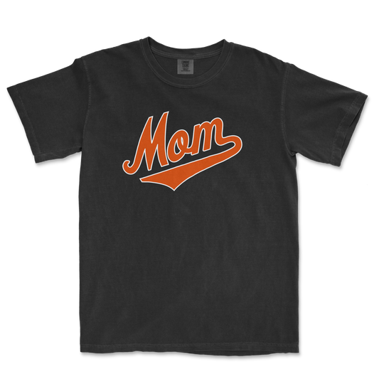 Black Comfort Colors T-shirt with "Mom" in orange script and underline, designed for Baltimore baseball moms.