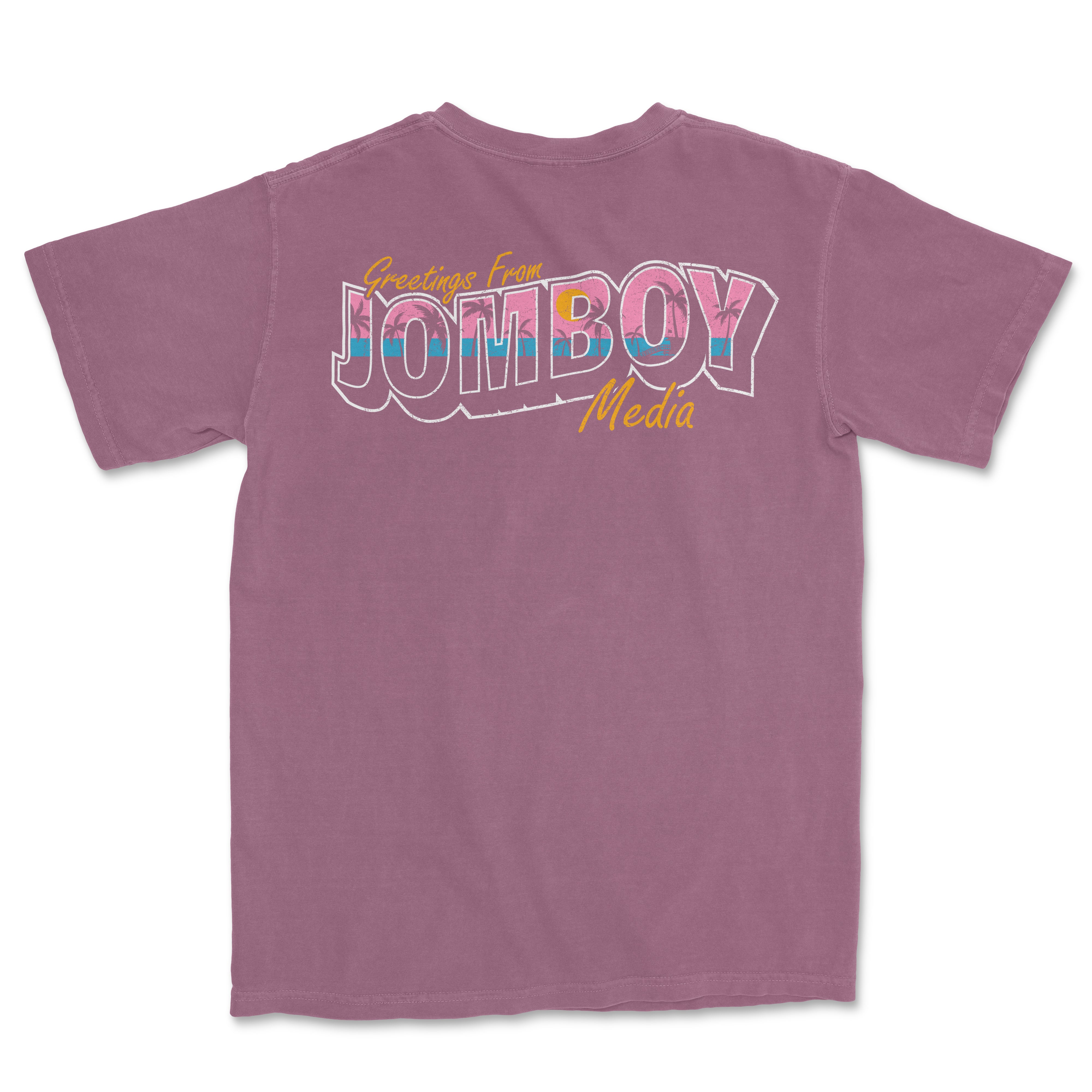 Back of a mauve Comfort Colors T-shirt featuring a colorful "Greetings from Jomboy Media" graphic design in pink, blue, yellow, and white.