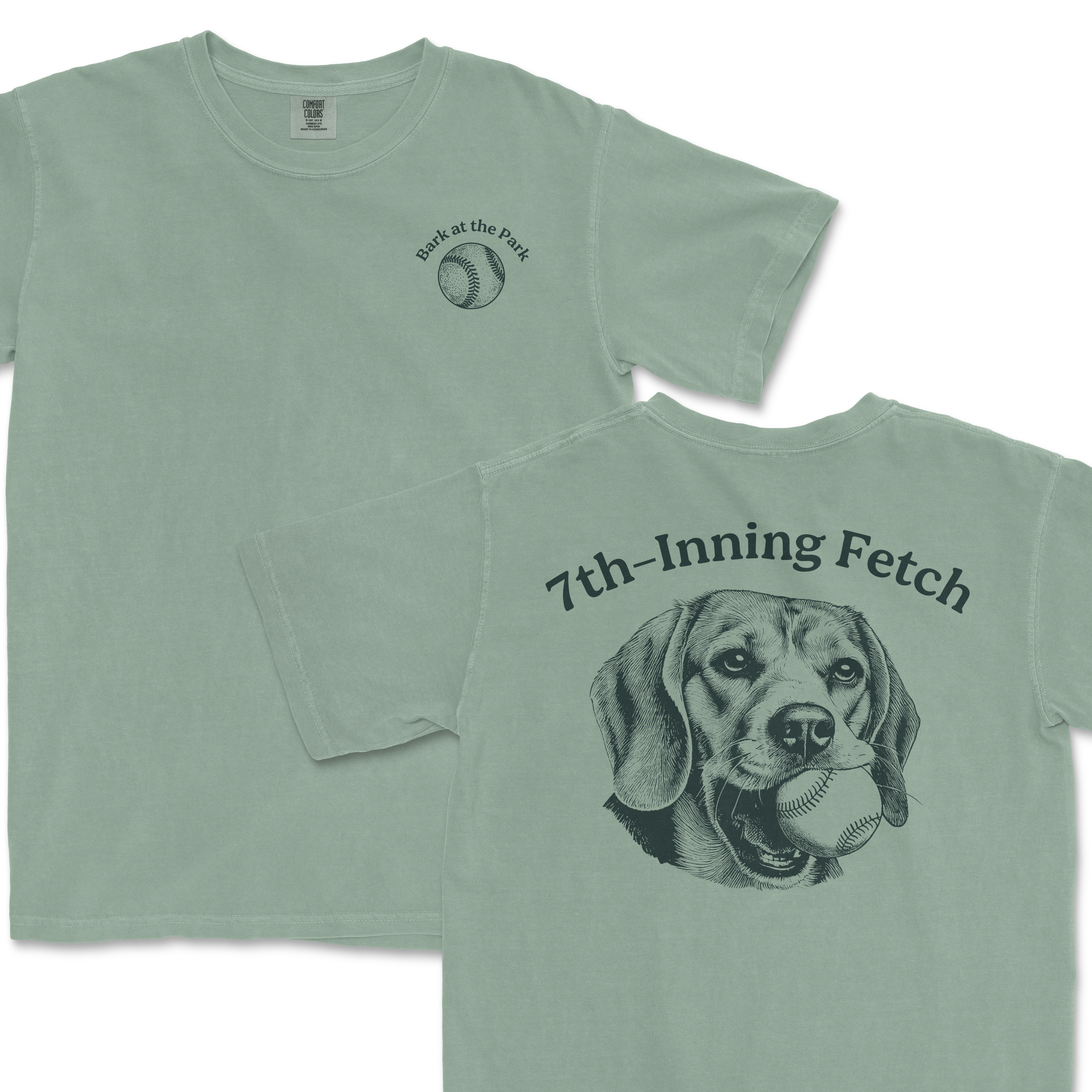Light green Comfort Colors T-shirt featuring a dog with a baseball in its mouth on the back and a small baseball graphic with "Bark at the Park" on the front.