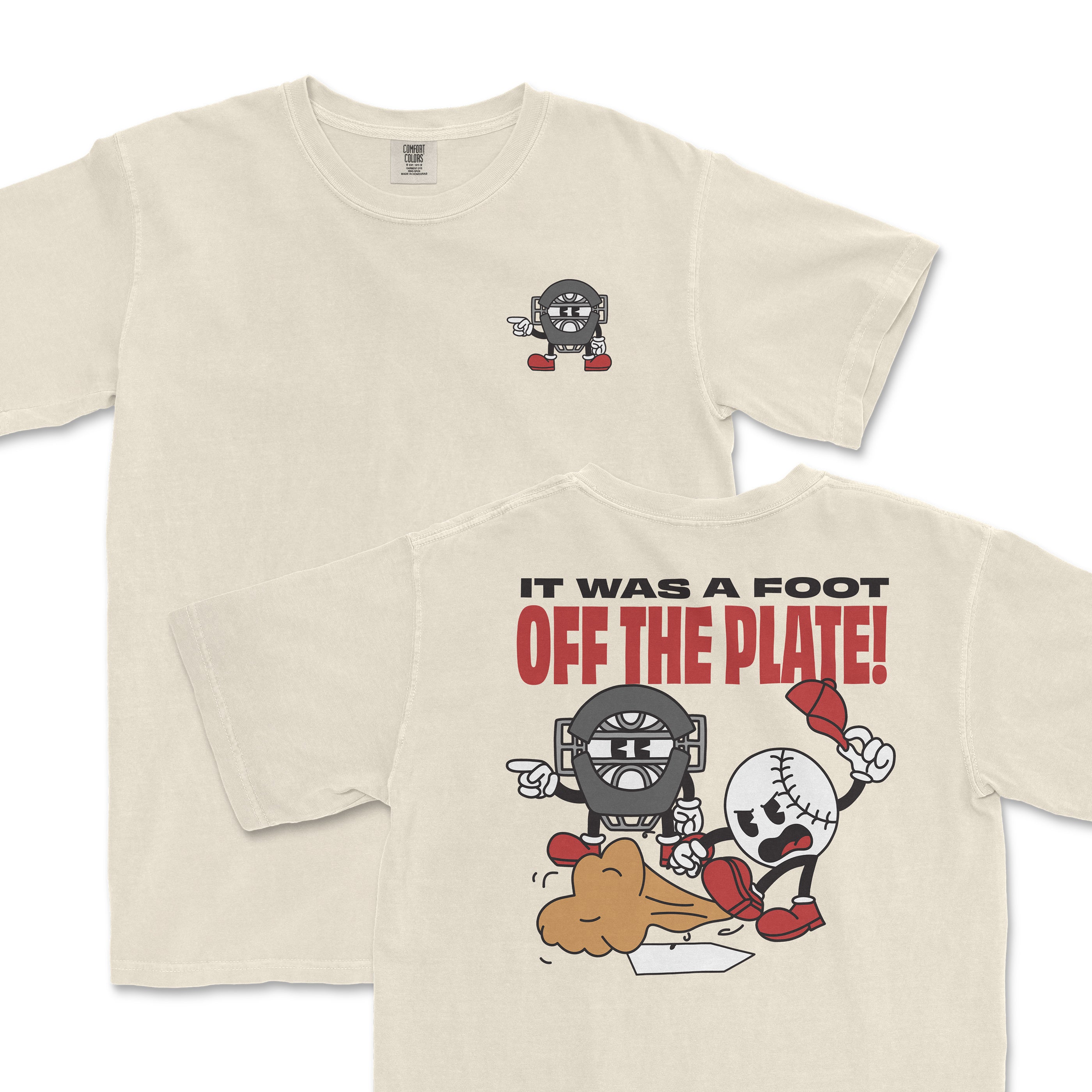 Cream-colored t-shirt featuring a cartoon character with a baseball theme and the phrase "It was a foot off the plate" on the back.