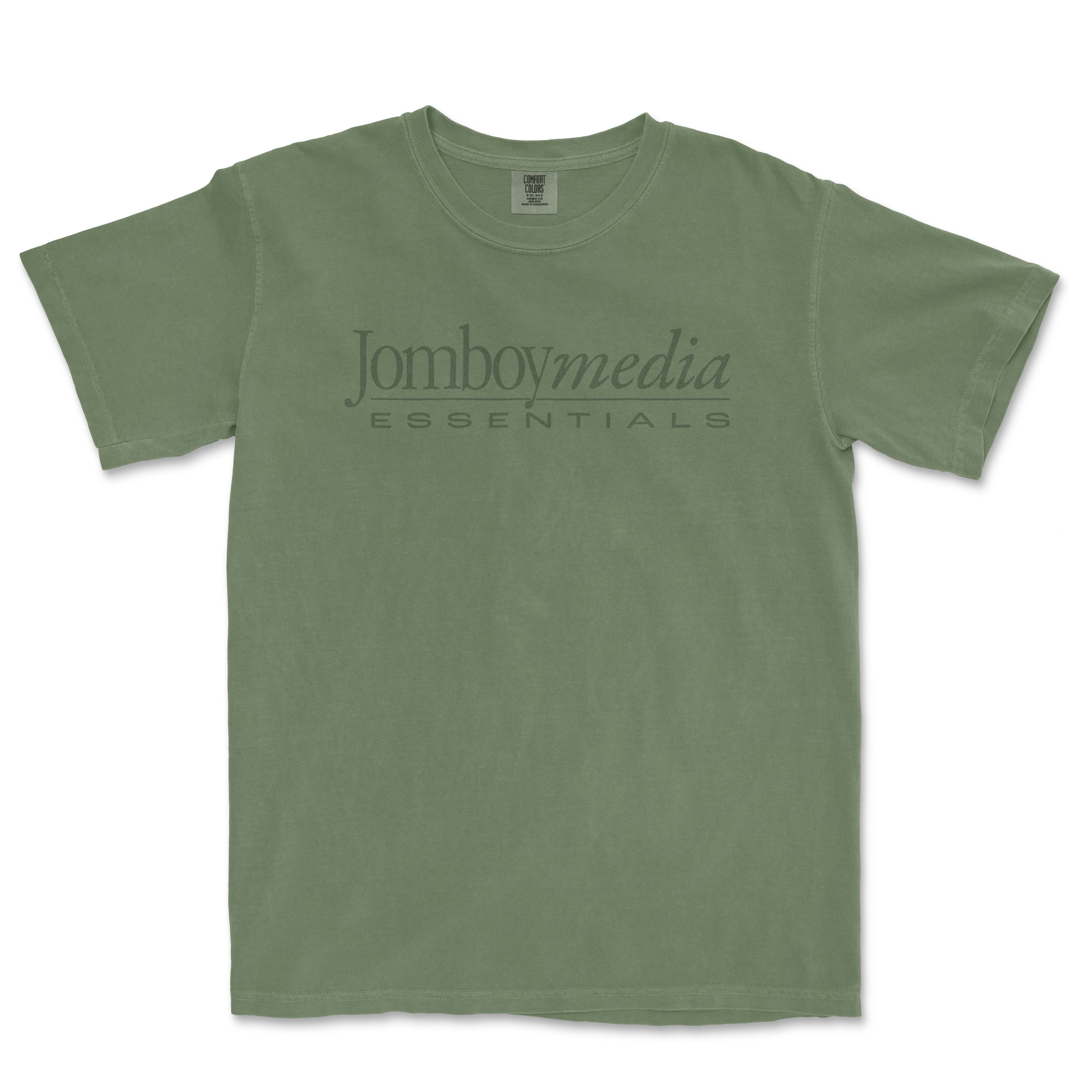 Green vintage-style T-shirt with "Jomboymedia Essentials" logo printed across the chest, inspired by 1980s fashion.