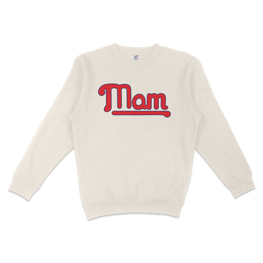Cream-colored crewneck sweatshirt with "Mom" in bold red and blue retro-style lettering across the front.