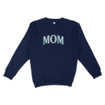 Navy blue crewneck sweatshirt with "MOM" printed in large, bold, light blue letters on the front, designed for Seattle baseball moms.