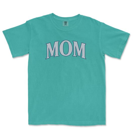 A turquoise T-shirt with the word "MOM" printed in large, stylized letters across the front.