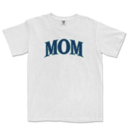 White T-shirt with "MOM" printed in bold, stylized blue letters across the chest, representing a Seattle baseball mom.