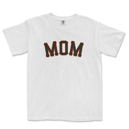 White T-shirt with "MOM" printed in bold black letters outlined in orange, designed for San Francisco baseball moms.