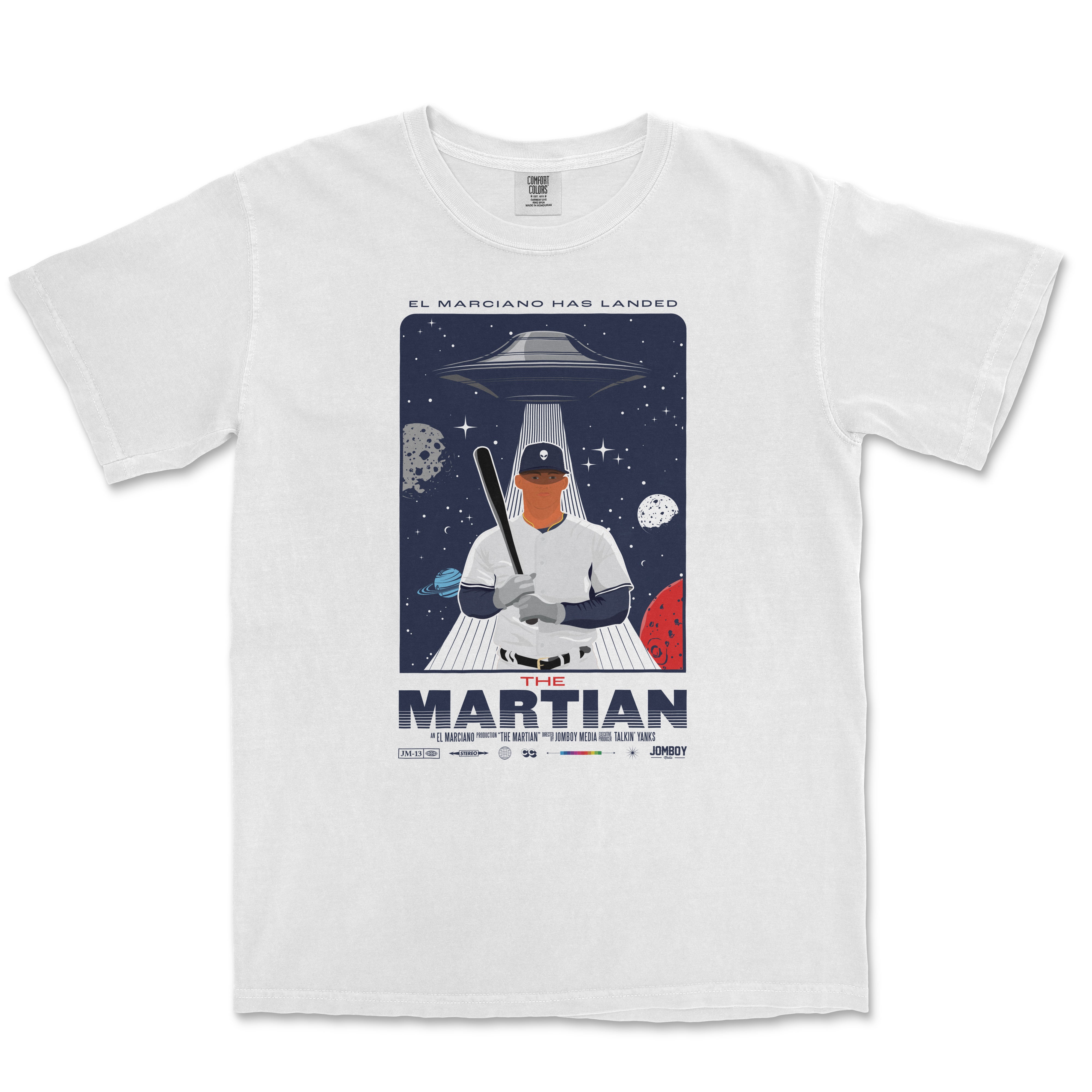 White T-shirt featuring an illustration of a baseball player with a UFO landing behind him, surrounded by planets and stars, with the text "The Martian" and "El Marciano Has Landed.