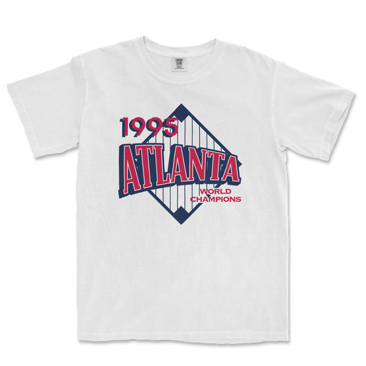 White Comfort Colors tee featuring a vintage 1995 Atlanta World Champions design with a stylized cityscape graphic.